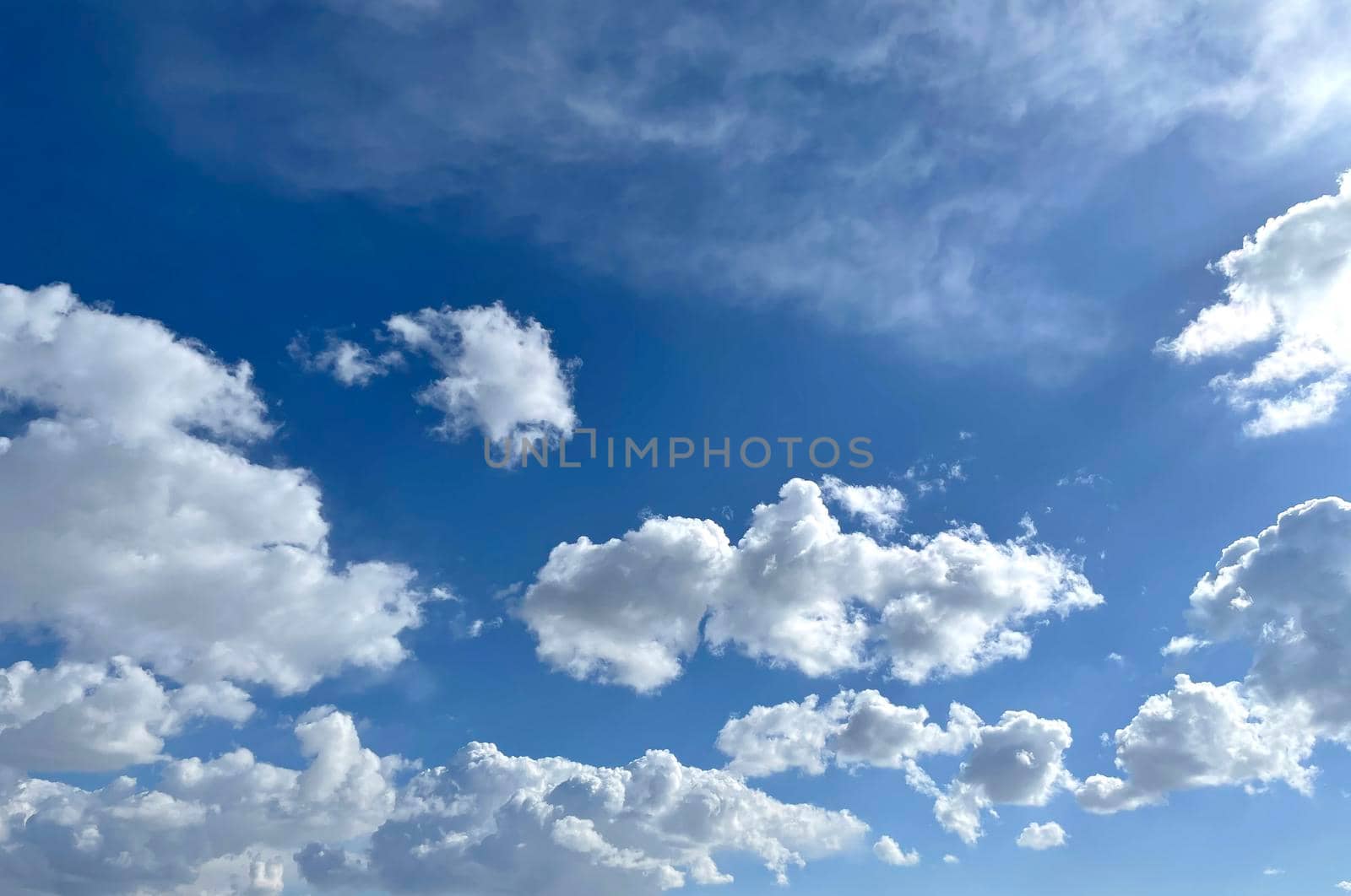 Bright sunny day, blue sky with snow-white different types of clouds