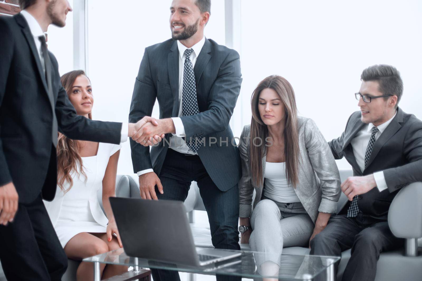 businessmen greet each other with a handshake by asdf