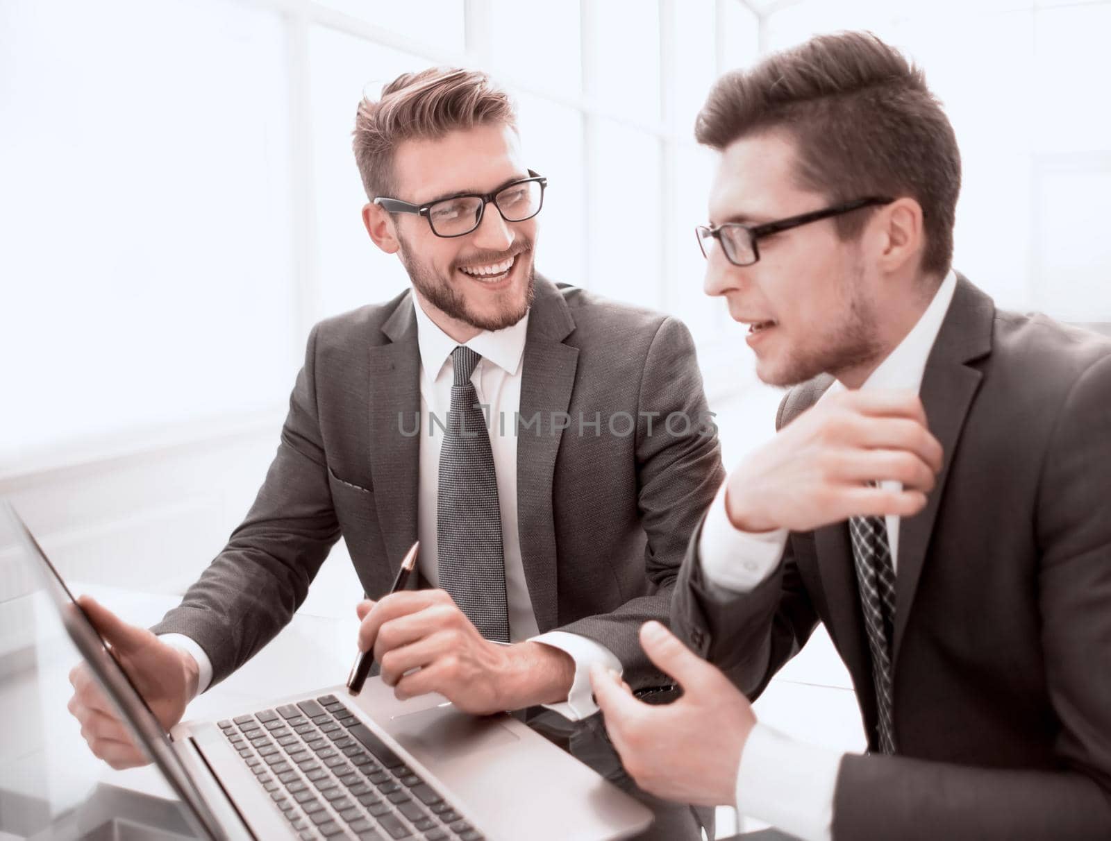 close up.business colleagues discuss new ideas, sitting at the Desk by asdf