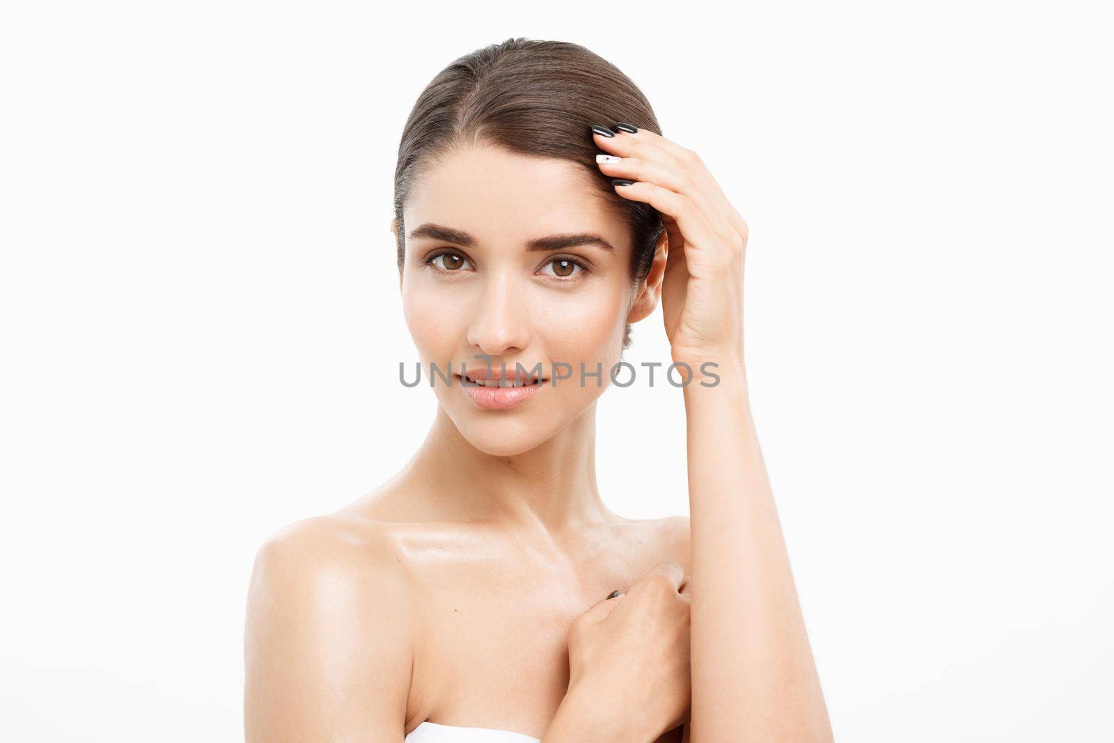 Beauty Skin Care Concept - Beautiful Caucasian Woman Face Portrait. Beautiful beauty young female model girl touching her face skin cheeks hands fingers. Fashion Beauty Model isolated on white.