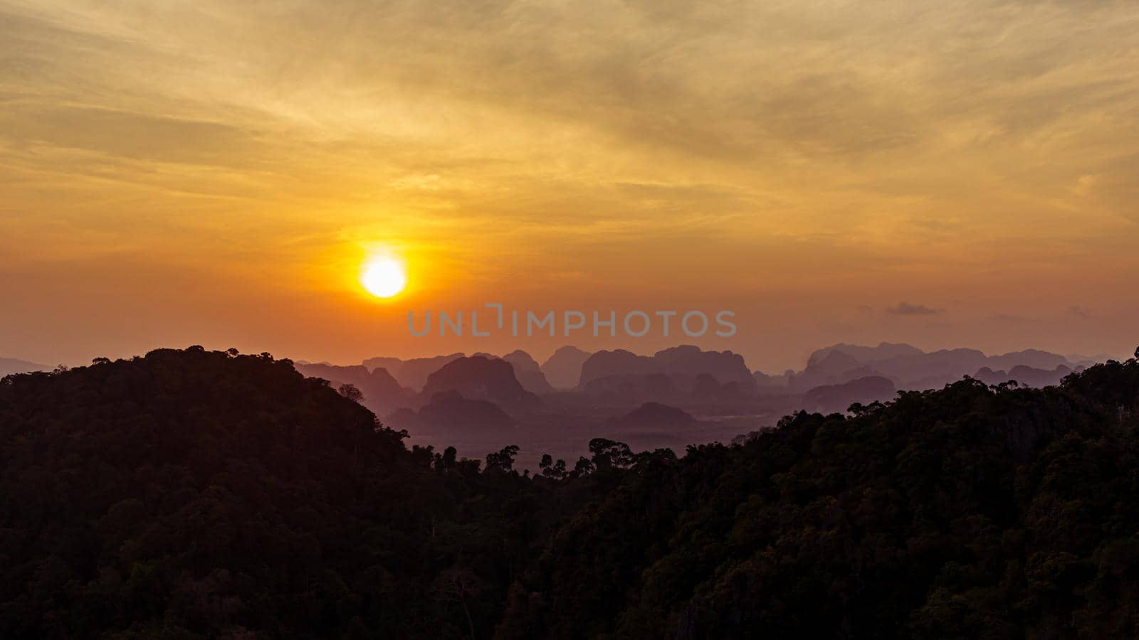 Beautiful evening sunset colors panoramic view from top, mountains in shadow