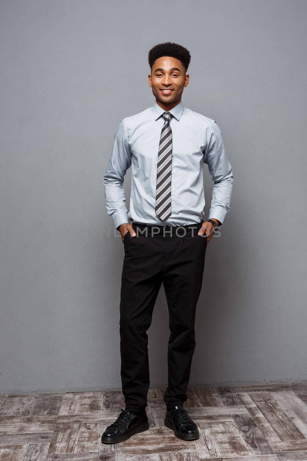 Business Concept - Full length portrait of confident african american businessman in the office. by Benzoix