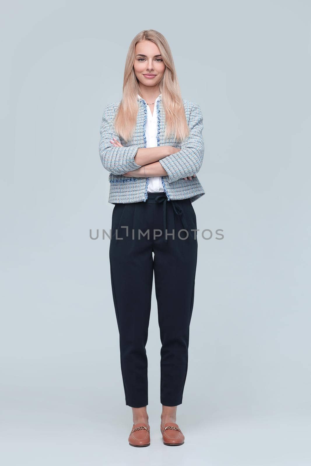 in full growth. confident young business woman. isolated on light background