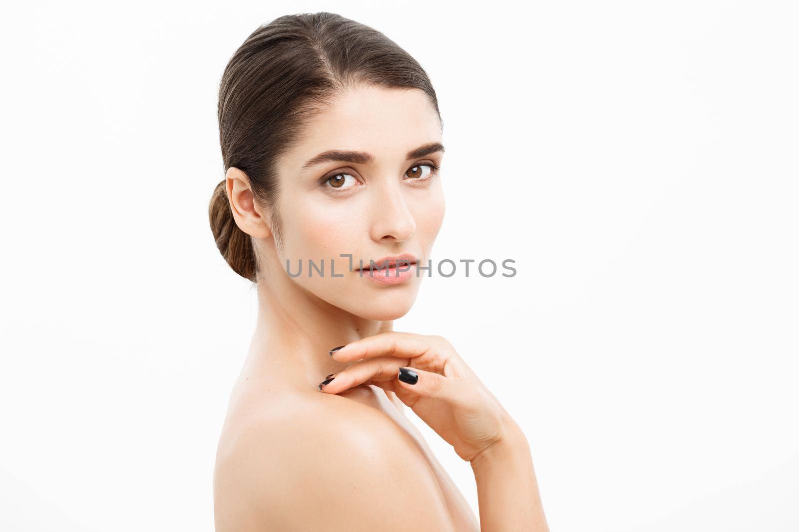 Beauty and Skin care concept - Close up Beautiful Young Woman touching her skin on white background