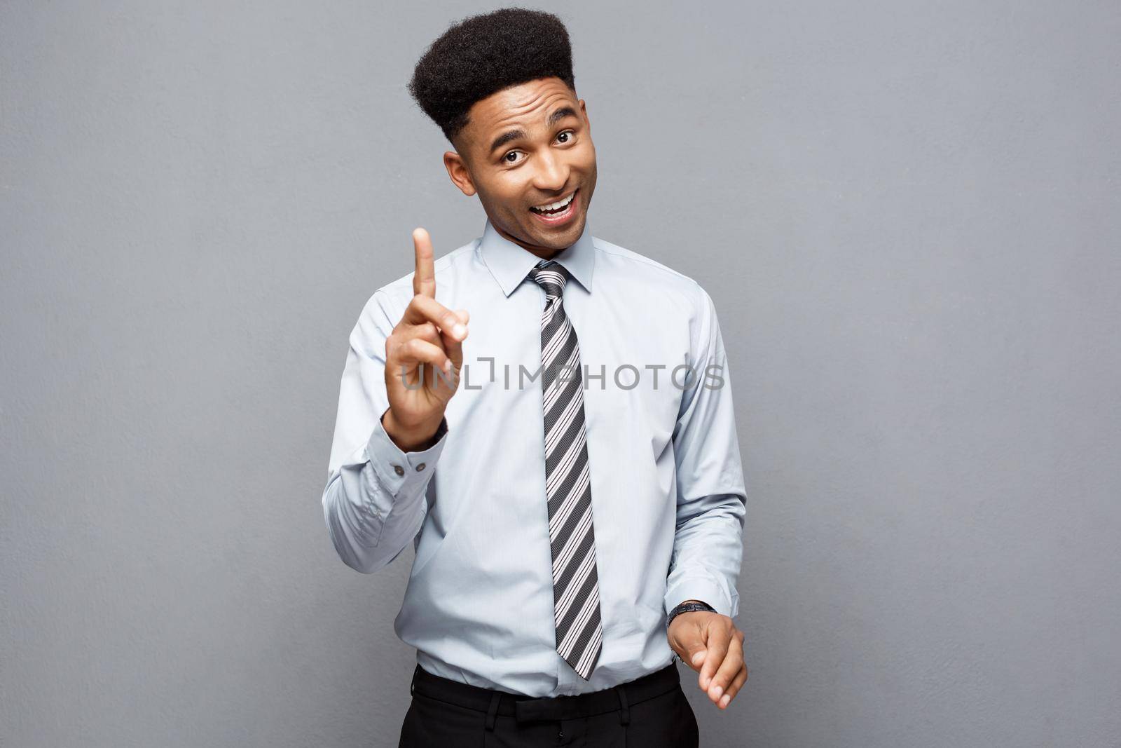 Business Concept - portrait of African American holding two peace or two fingers sign. by Benzoix