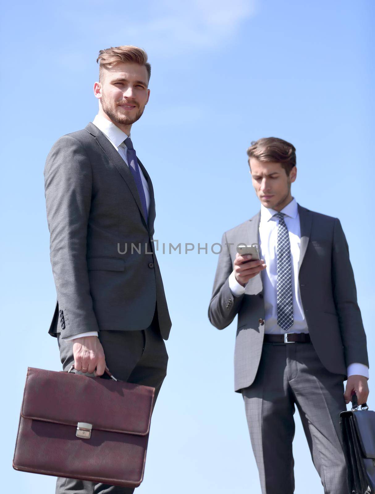 two modern business people standing on the street .business people