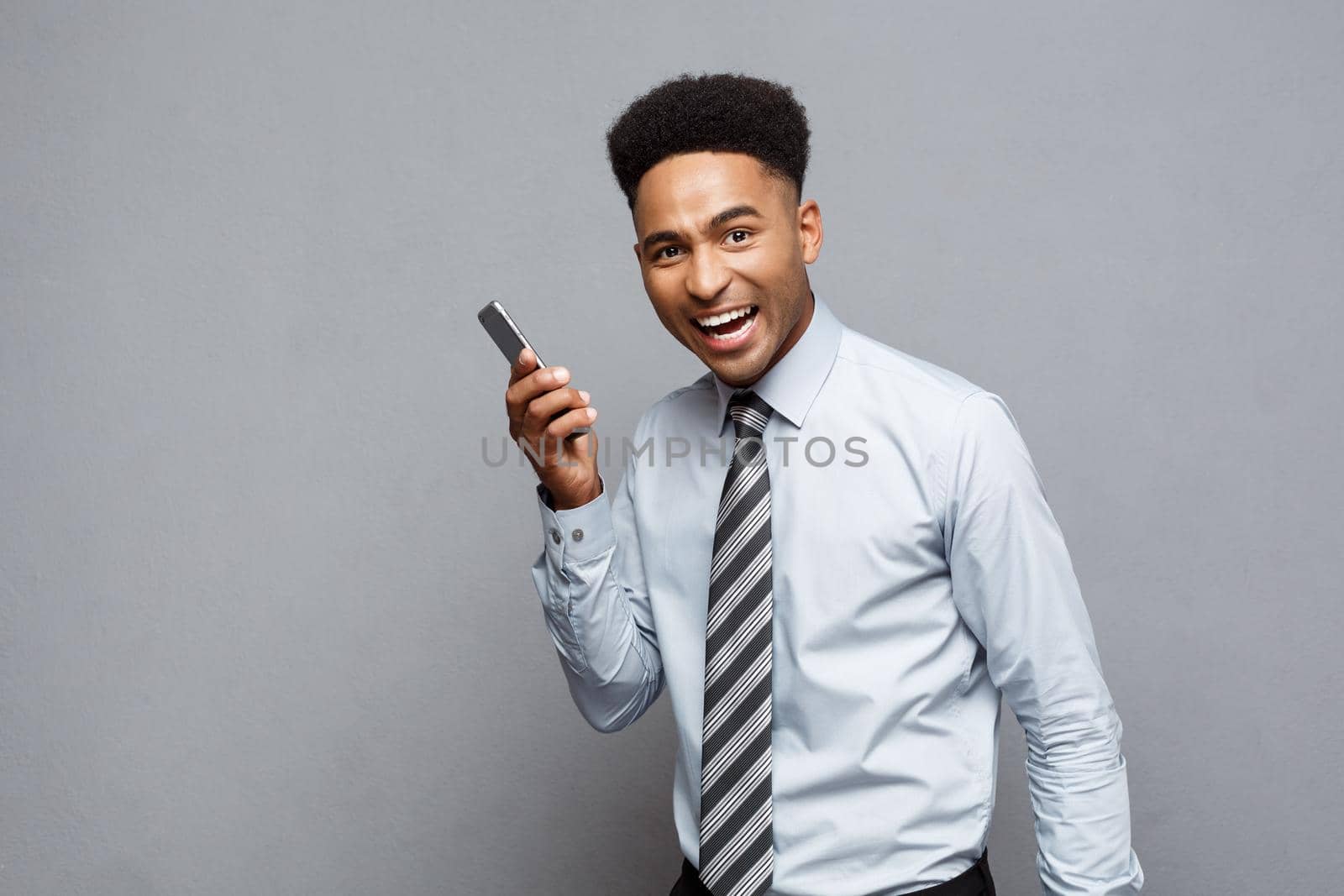 Business Concept - Cheerful professional african american businessman happy talking on mobile phone with client
