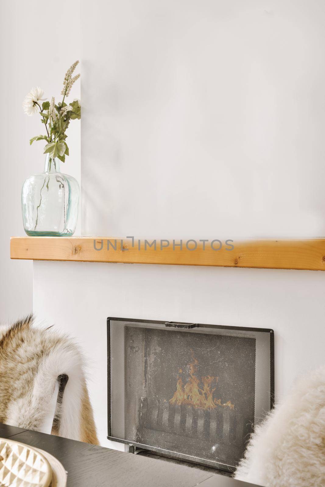 Contemporary fireplace with glass screen installed in white wall in living room at home