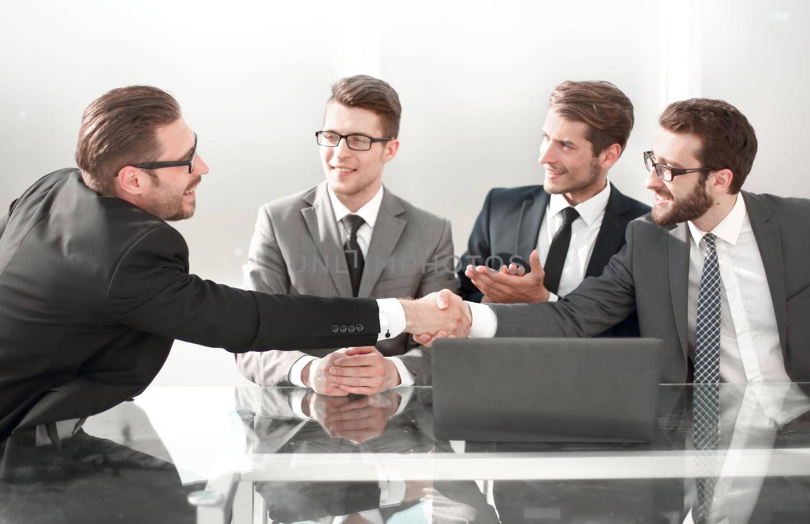 employees greet each other with a handshake by asdf