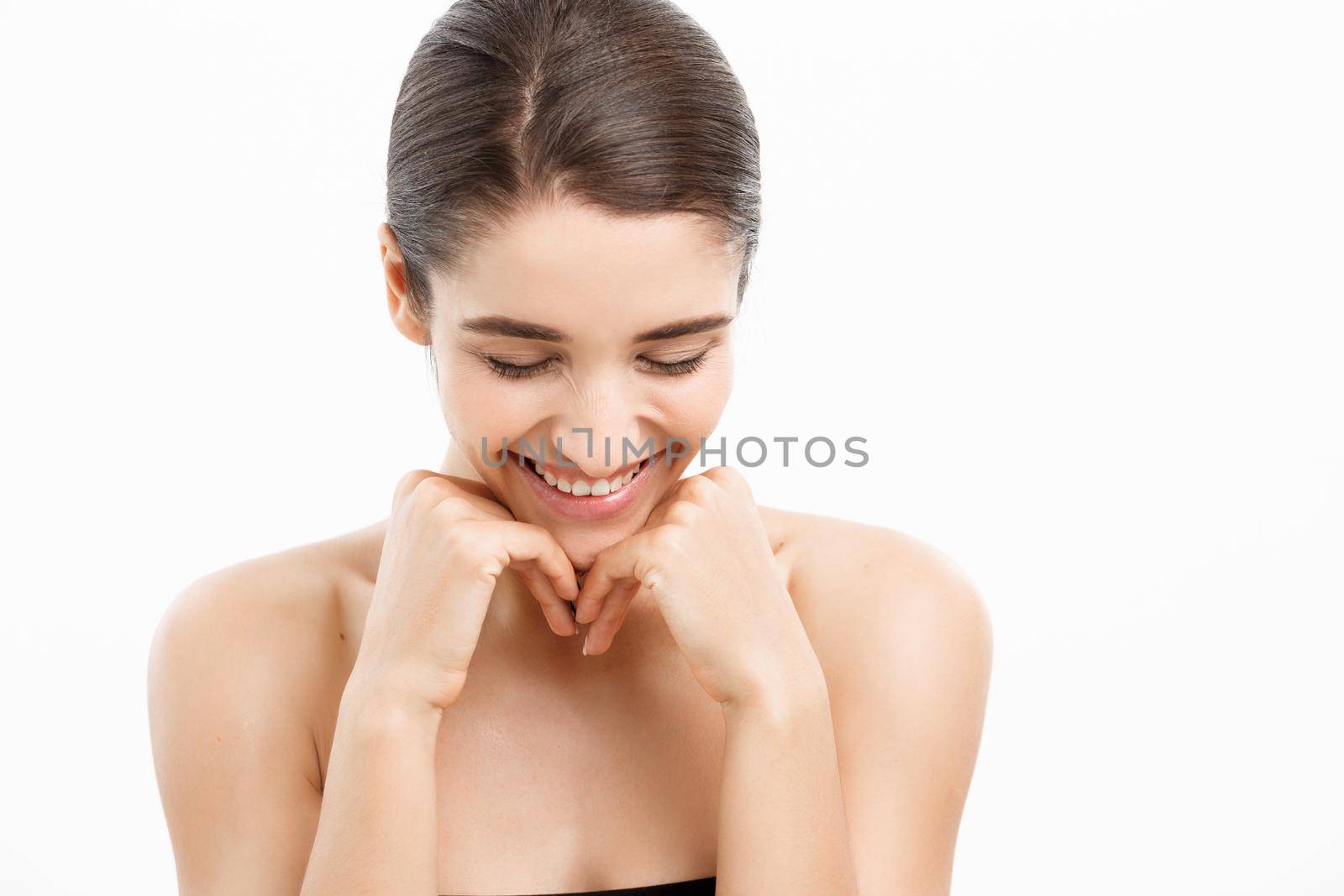 Beauty and spa concept - Charming young woman with perfect clear skin over white background