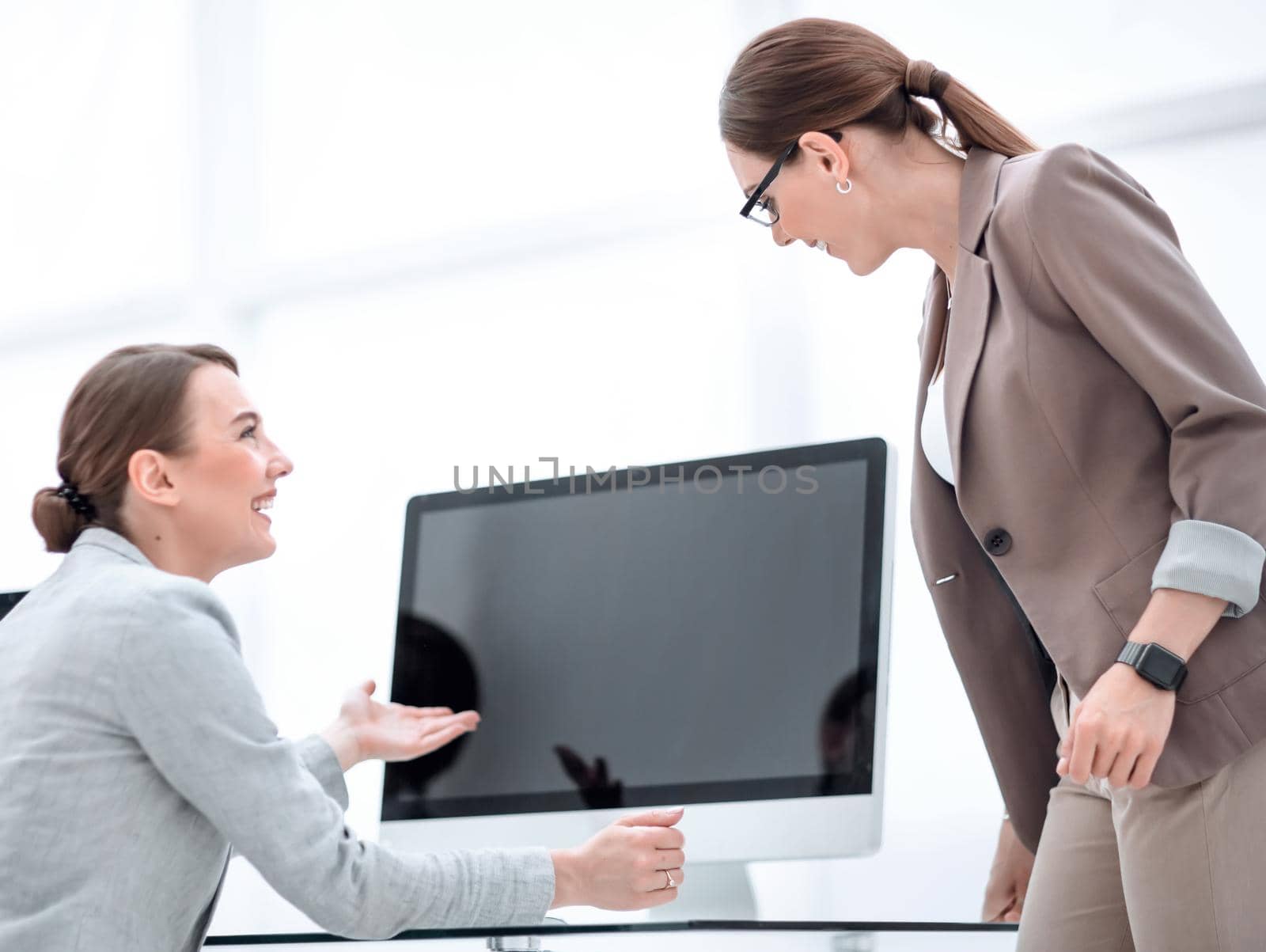 business woman uses computer sitting at office Desk. by asdf