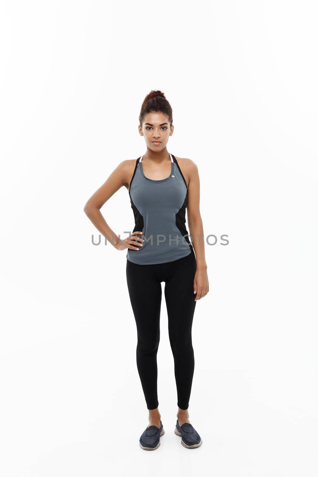 Healthy and Fitness concept - portrait of African American girl posing with fitness clothes over white studio