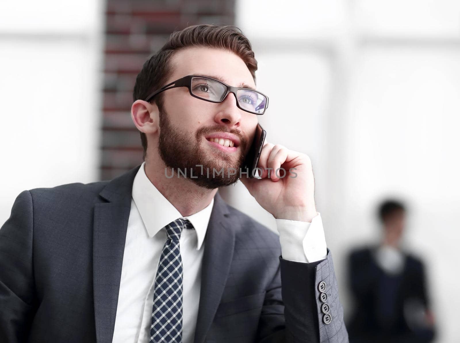View of a Young attractive business man using smartphone by asdf