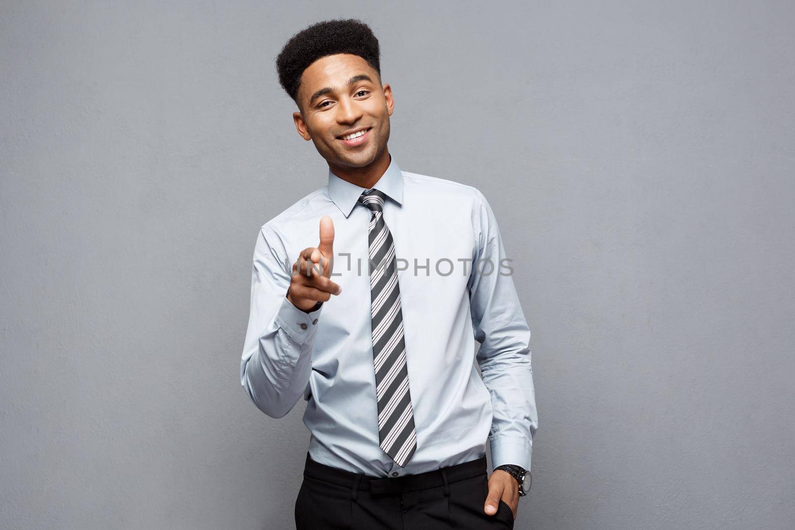 Business Concept - Cheerful happy young African American holding gun sign with fingers pointing to other