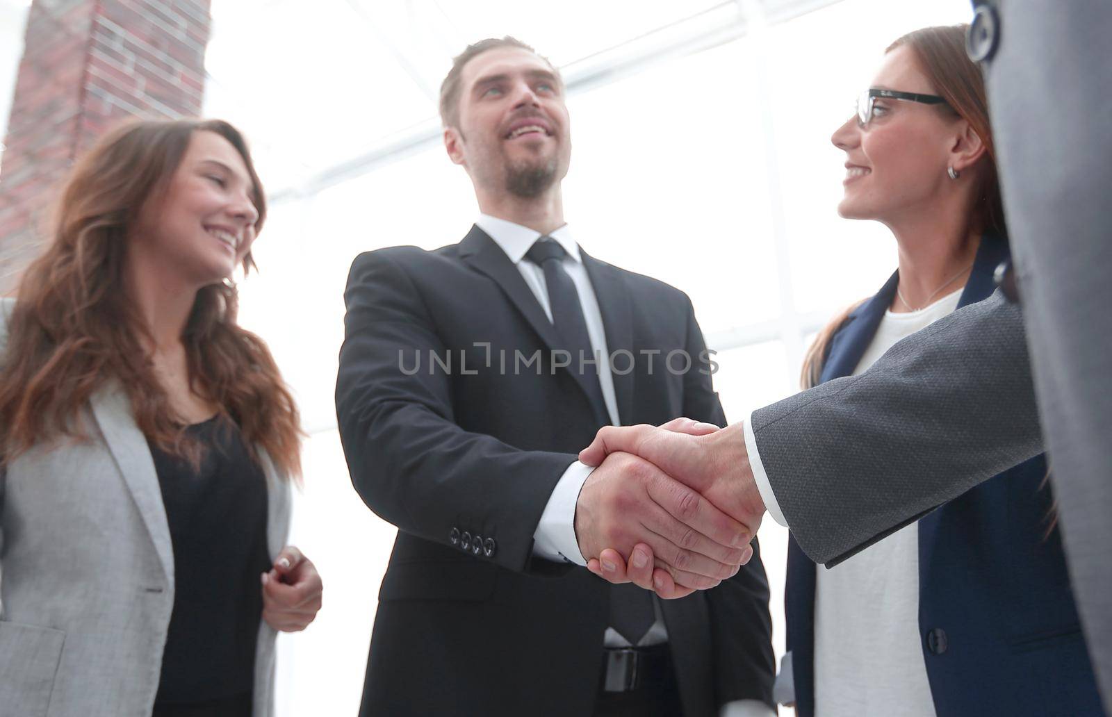 businessmen shaking hands in conference room by asdf