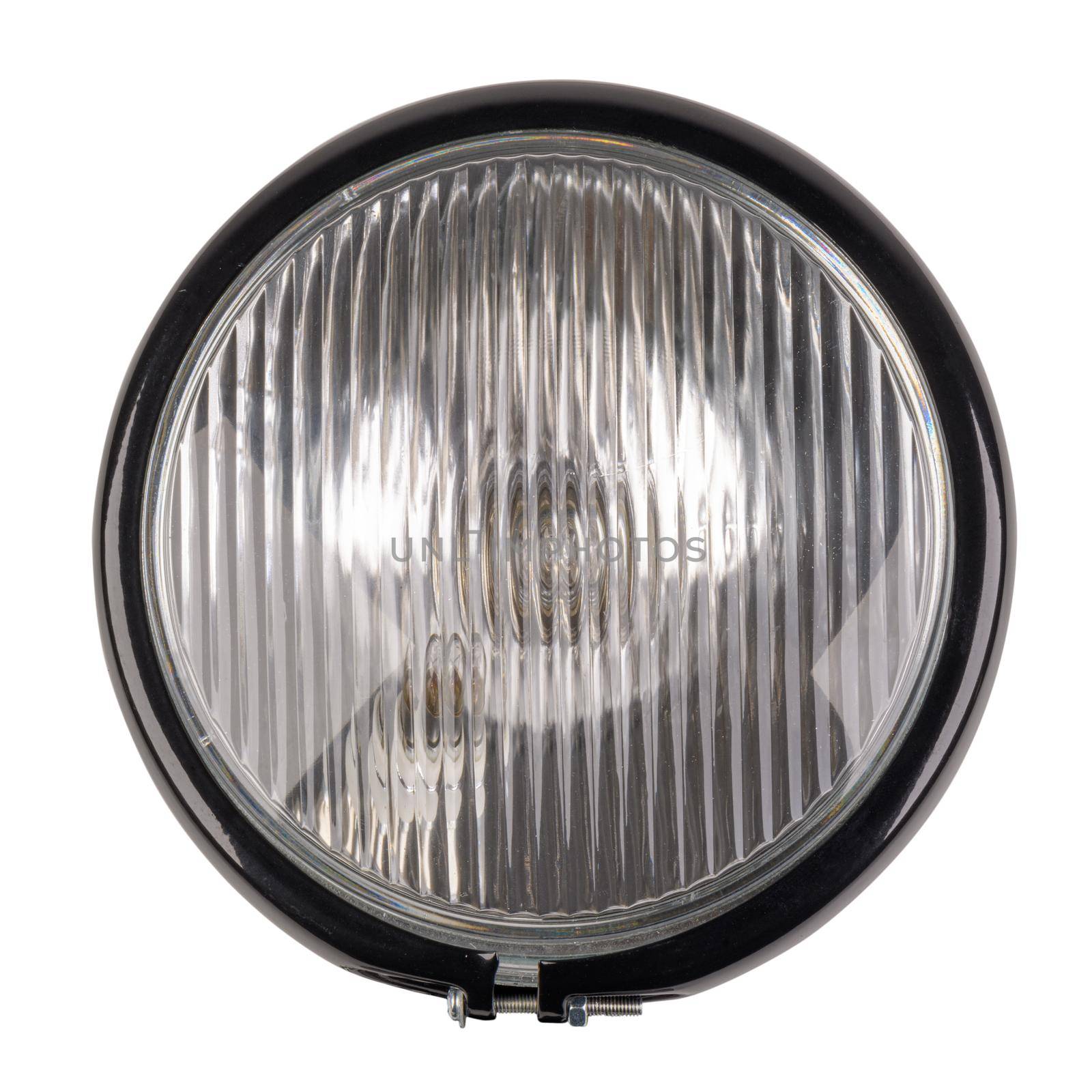 Close-up motorcycle headlight isolated in a white background.