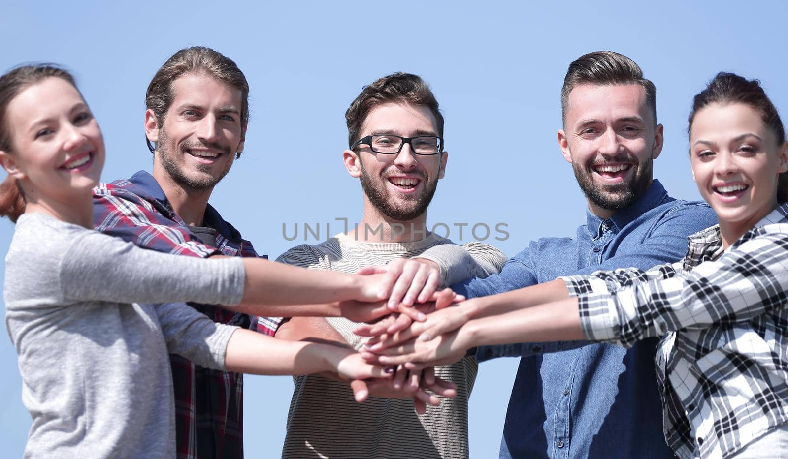 closeup.a team of young people shows their unity.photo with copy space