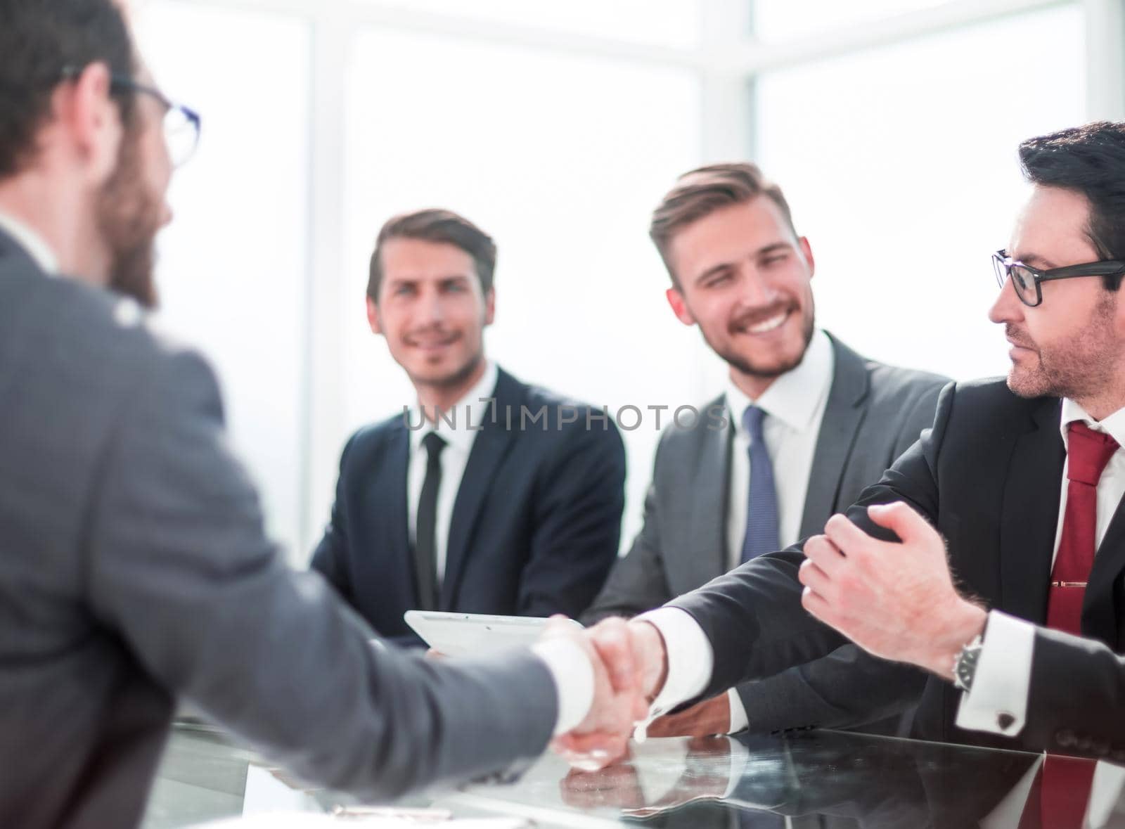 business hands shaking hands sitting at the office Desk.concept of partnership