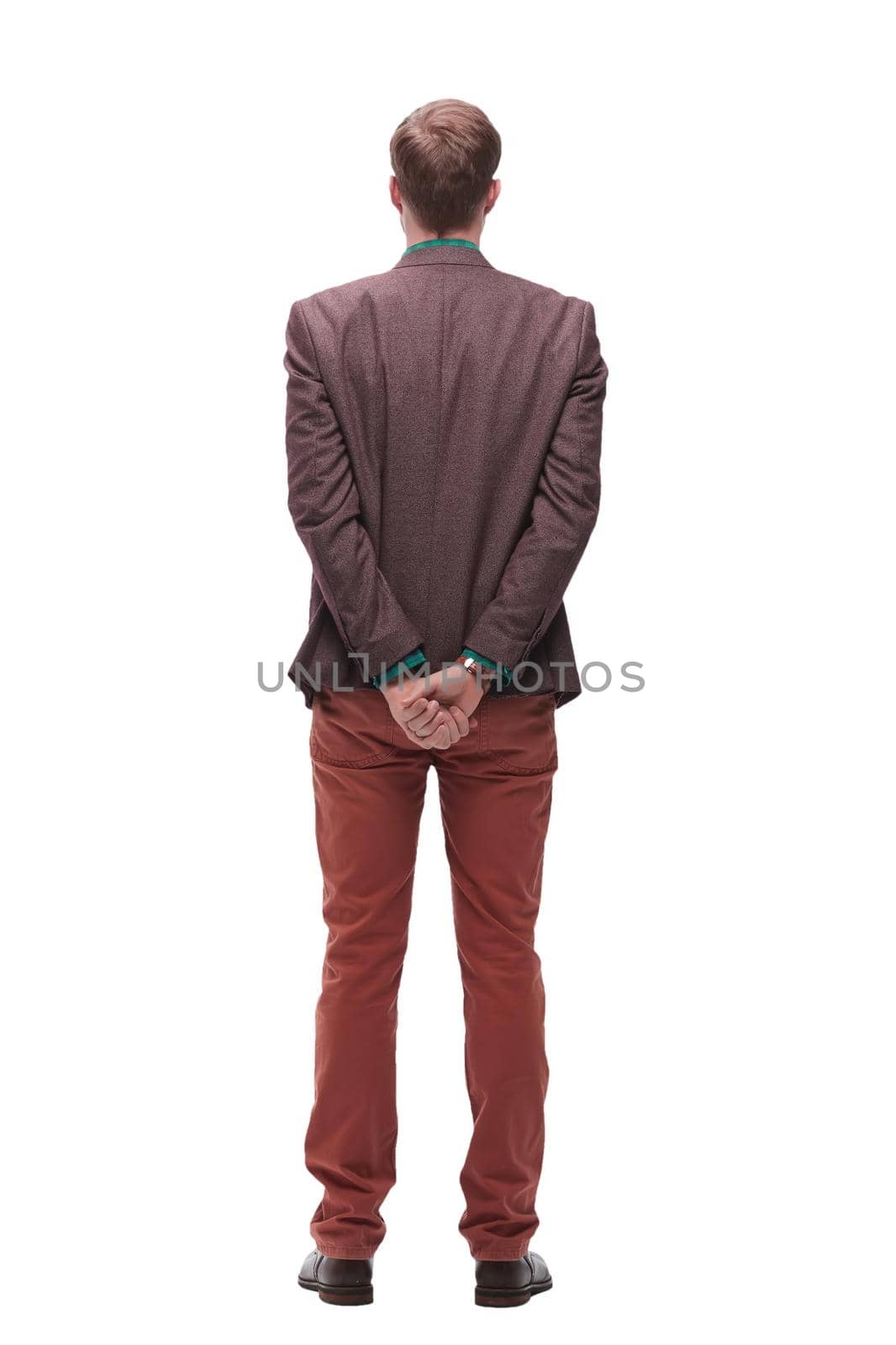 rear view. young man standing in front of white blank screen. isolated on white background