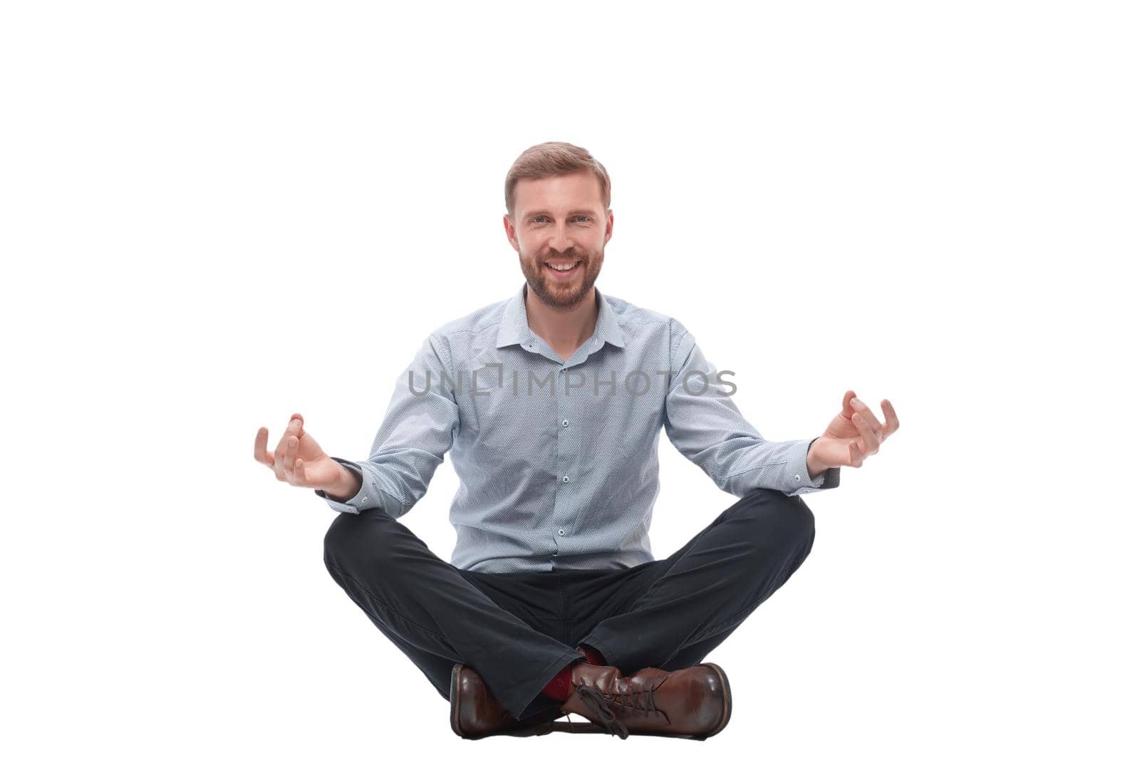 young businessman meditates sitting on the floor by asdf