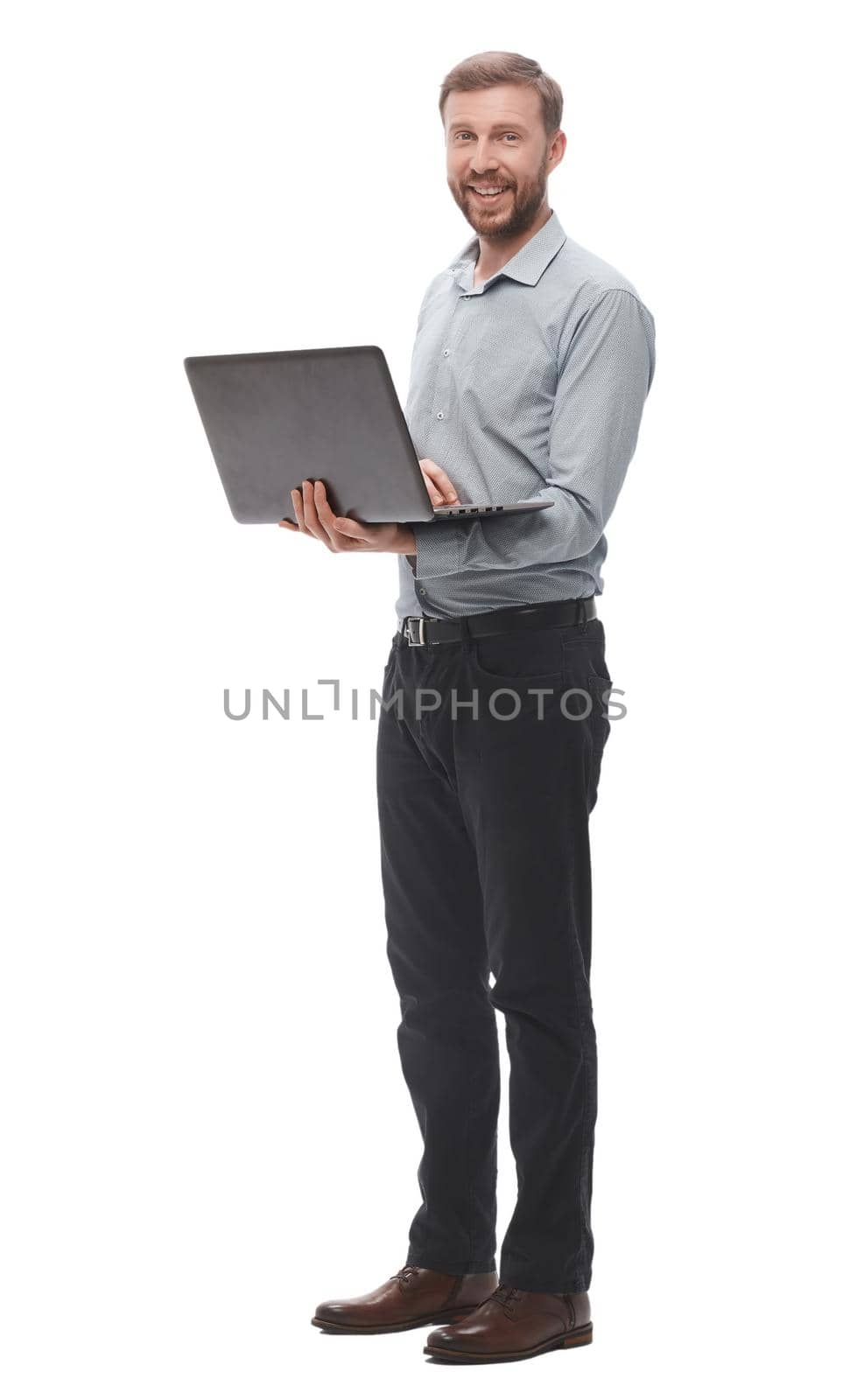 in full growth. smiling young businessman with laptop. isolated on white background