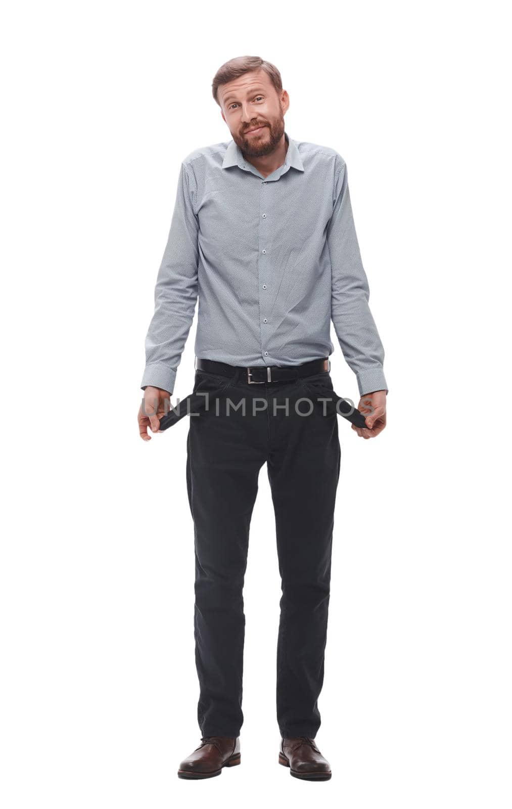 in full growth. businessman showing empty pockets.isolated on white background