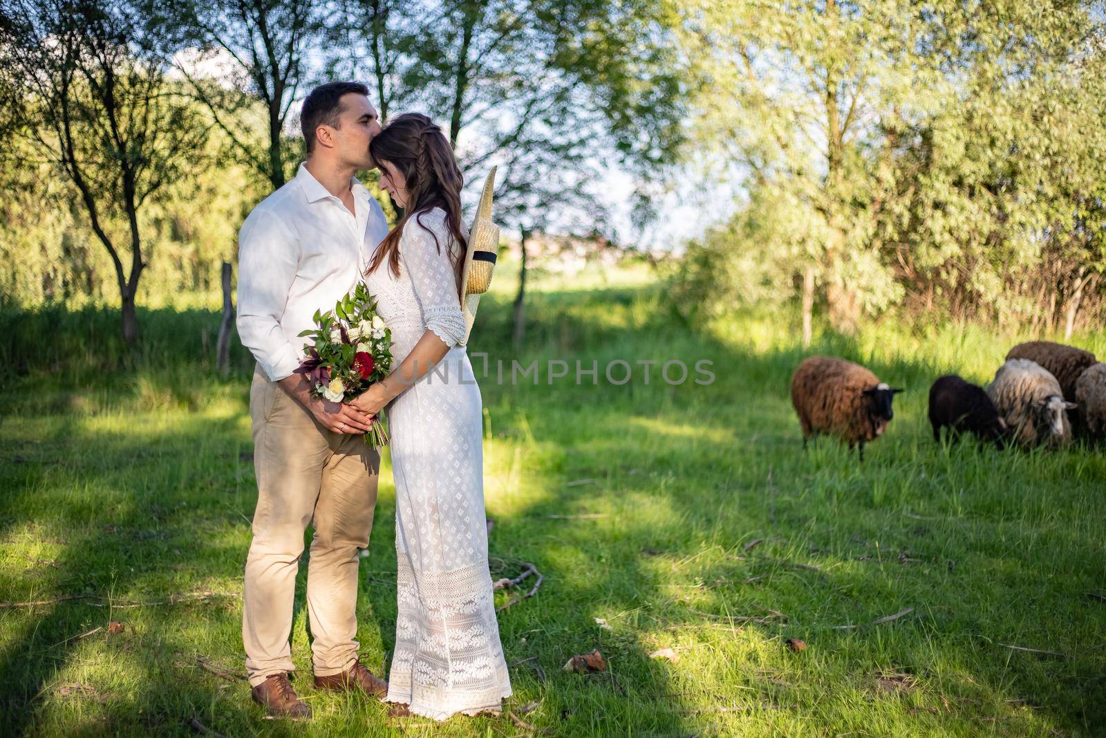 General plan of Caucasian brides kissing top view.nice portrait of beautiful and young groom and bride outdoors by Anyatachka