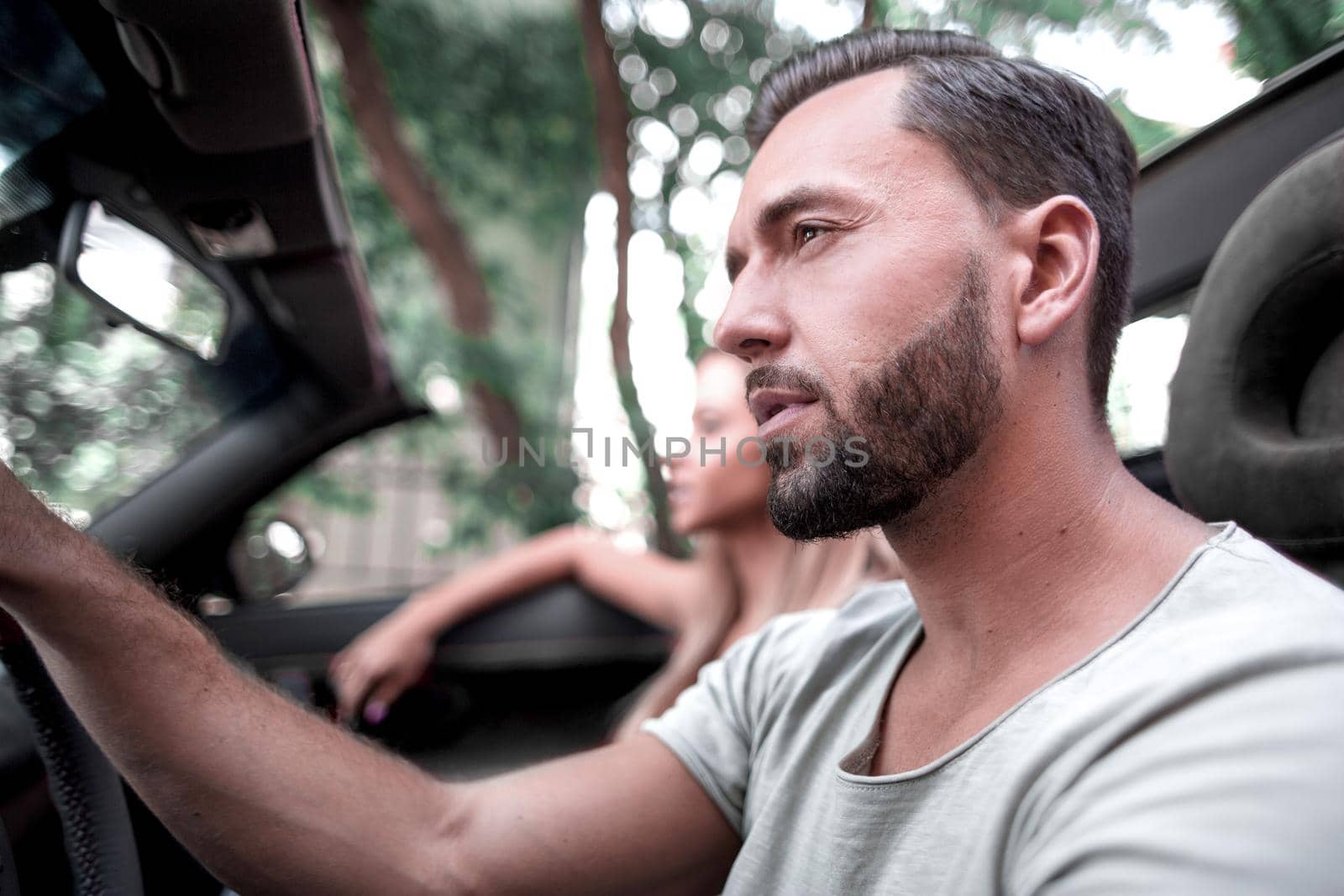 close up.a handsome man driving a luxury car.the concept of lifestyle