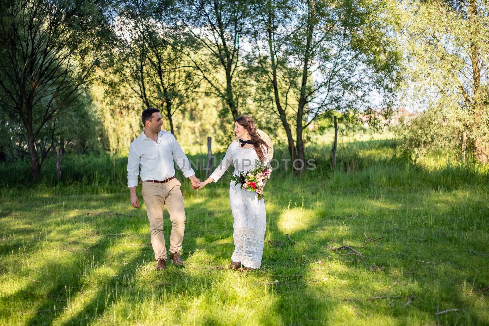 nice portrait of beautiful and young groom and bride outdoors