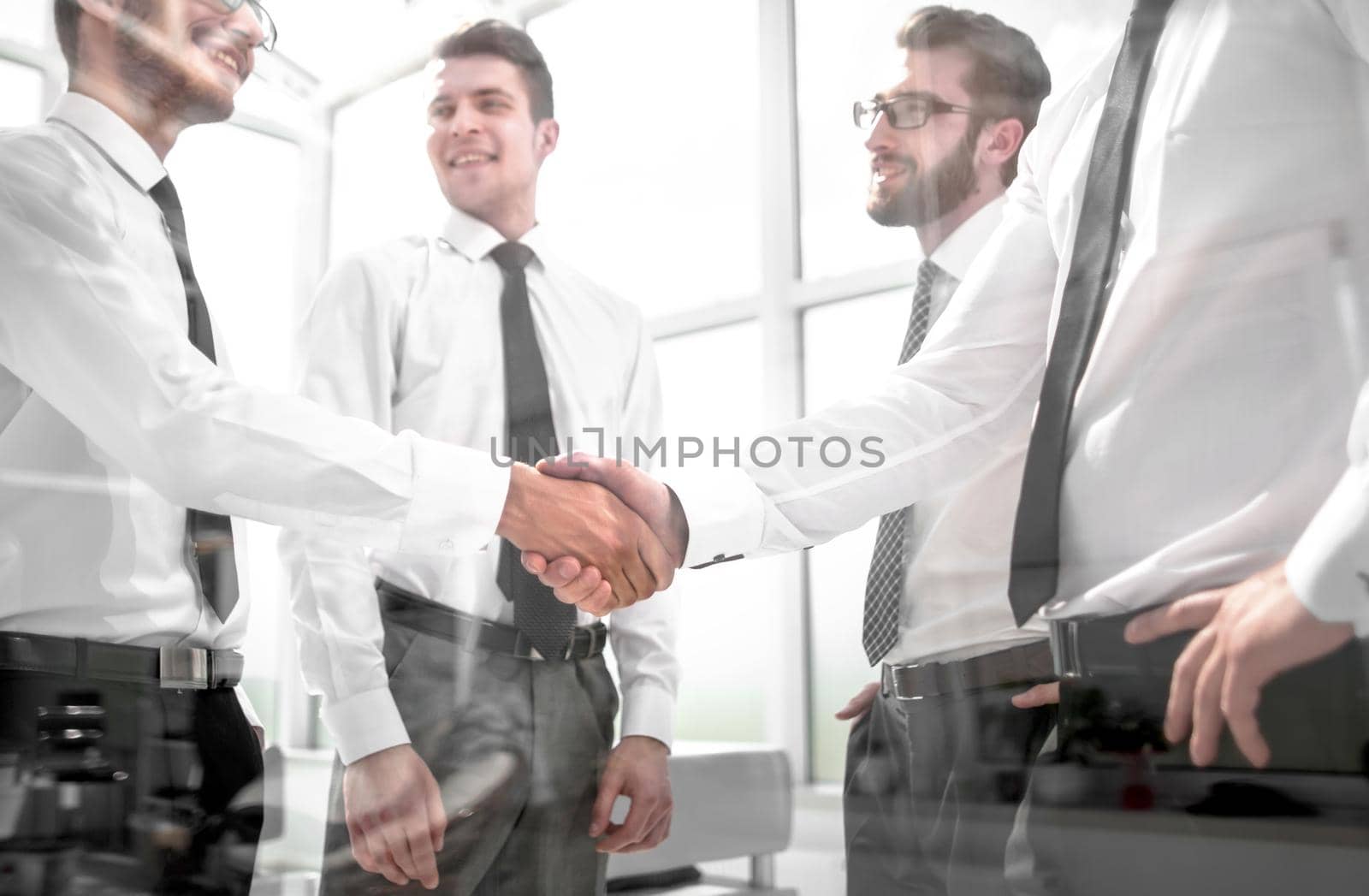 business colleagues shaking hands in the office by asdf