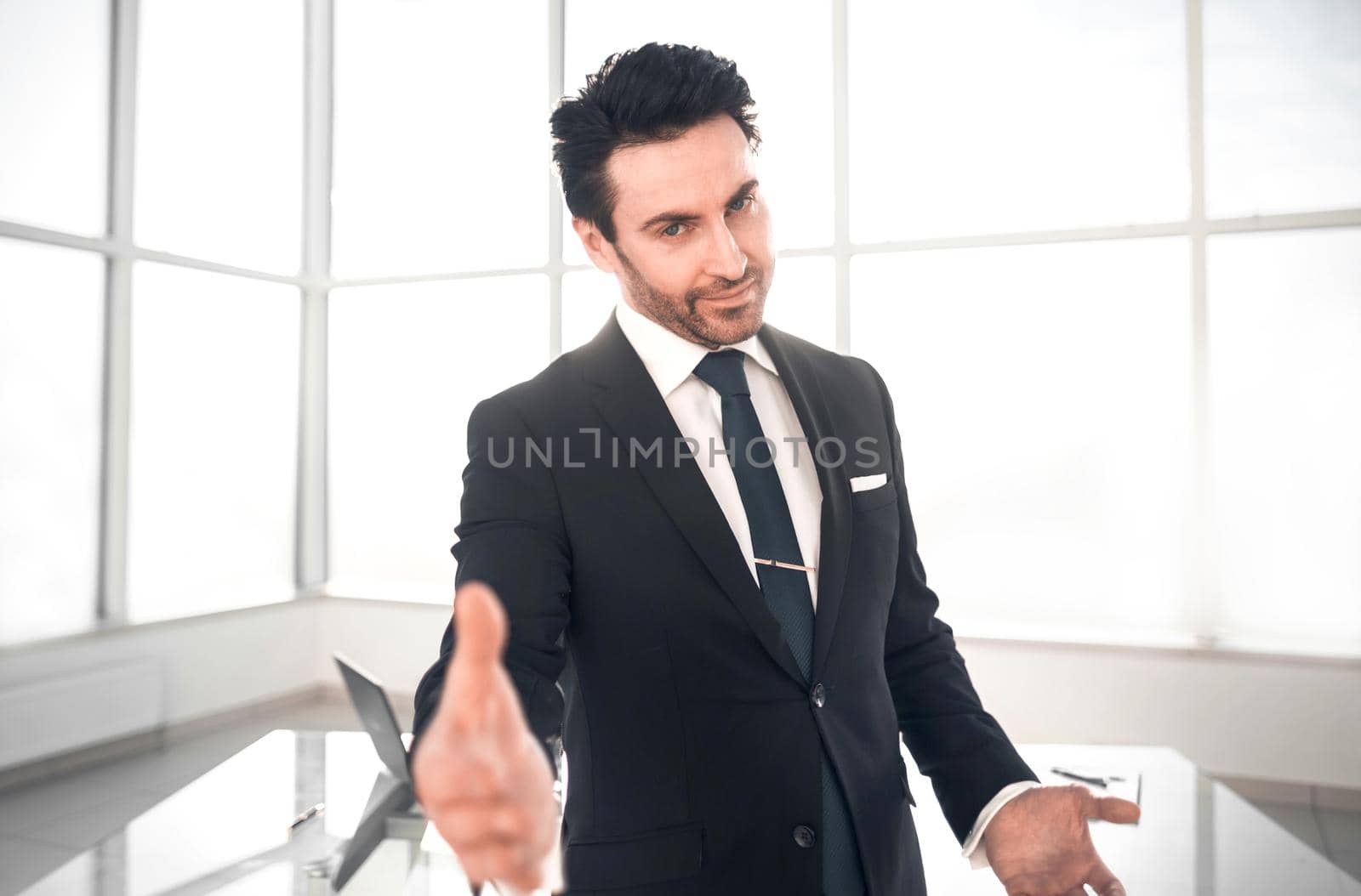 friendly businessman standing in his office.photo with copy space