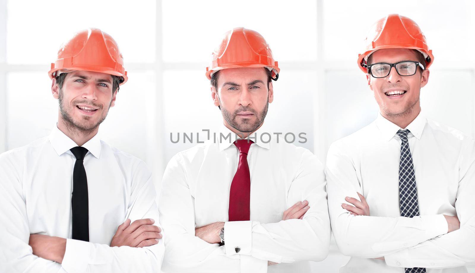 close up.three confident business men in protective helmets by asdf