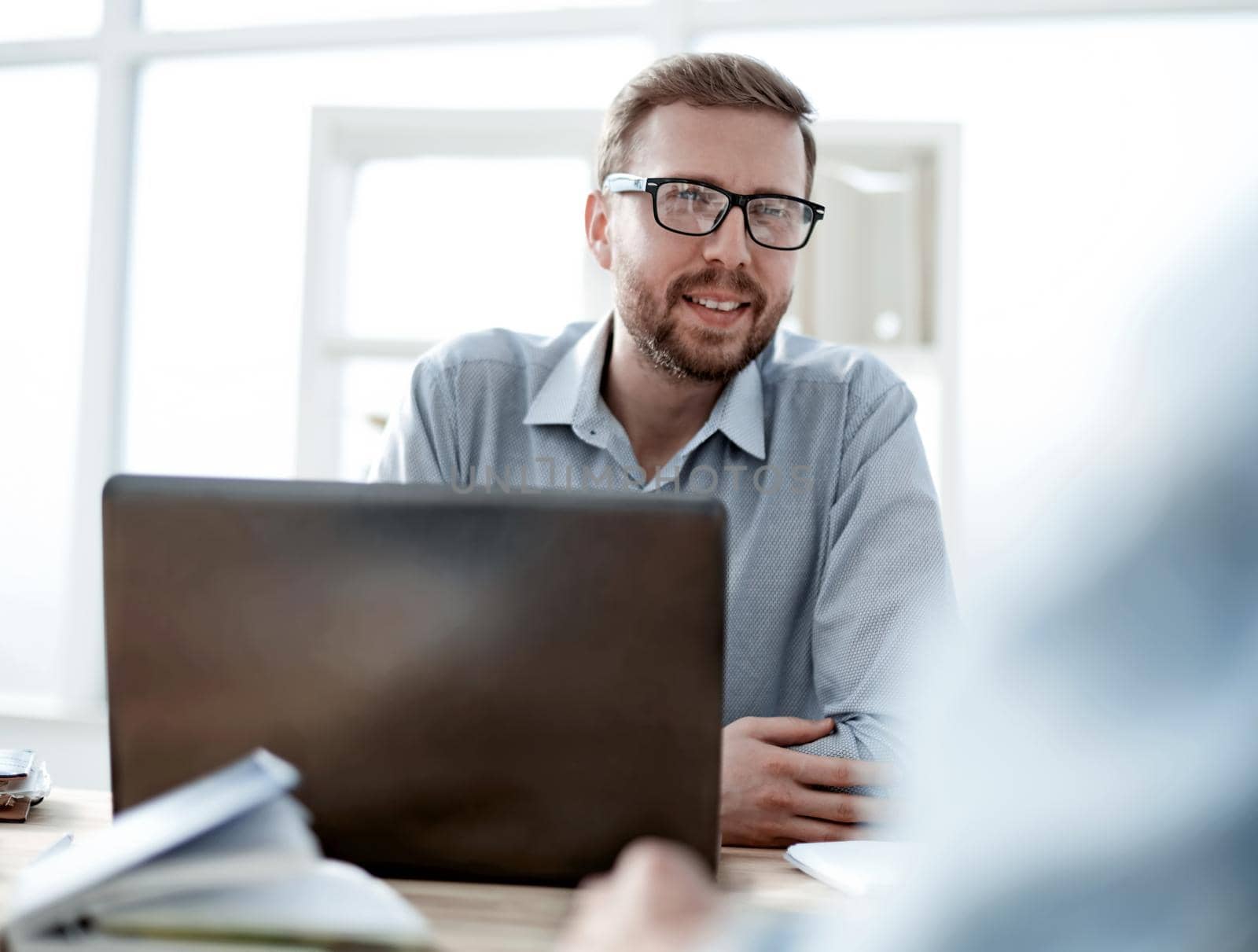 close up. attractive businessman sitting at the office Desk. office weekdays