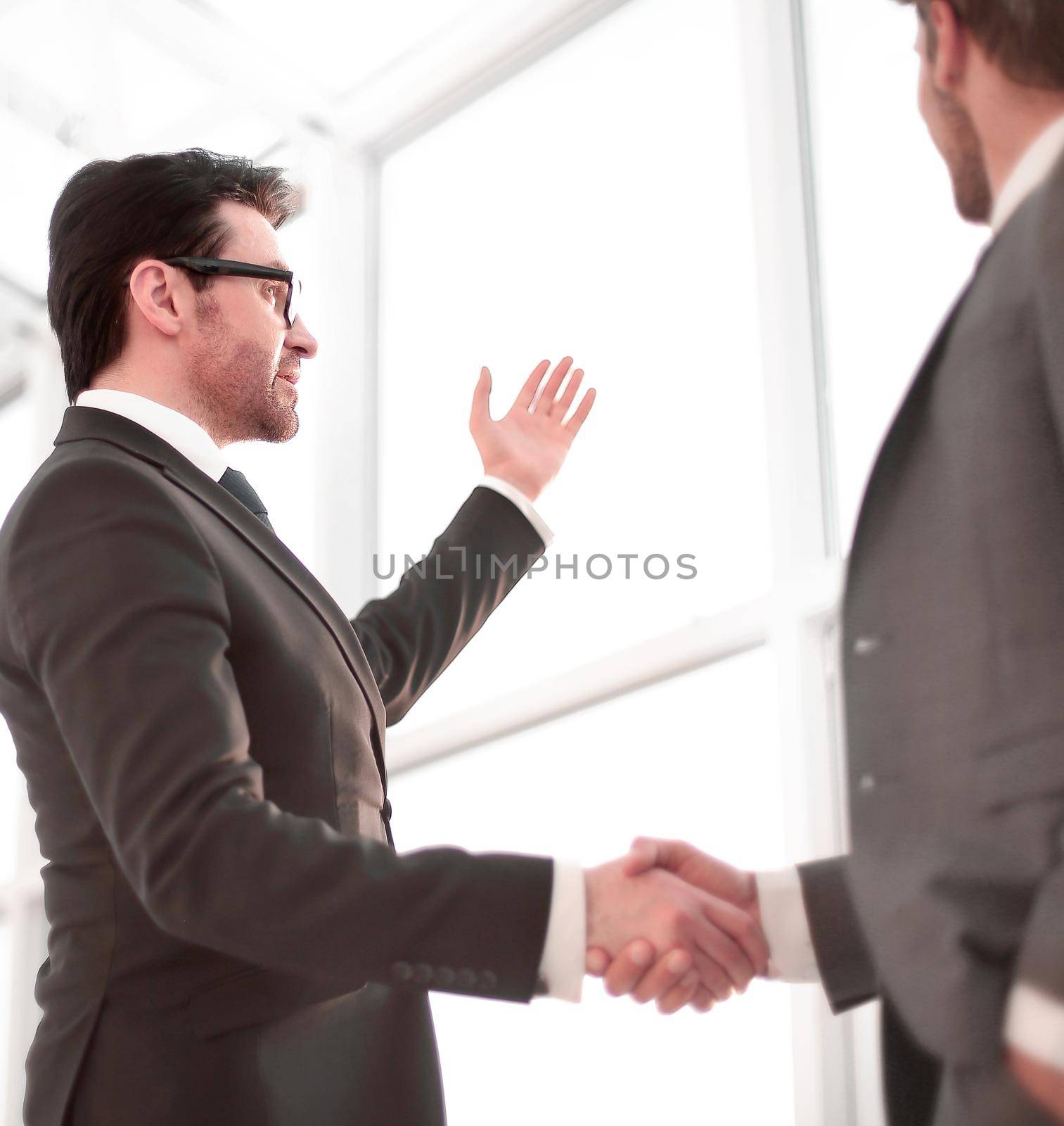 close up. businessmen shaking hands during a conversation in the office by asdf