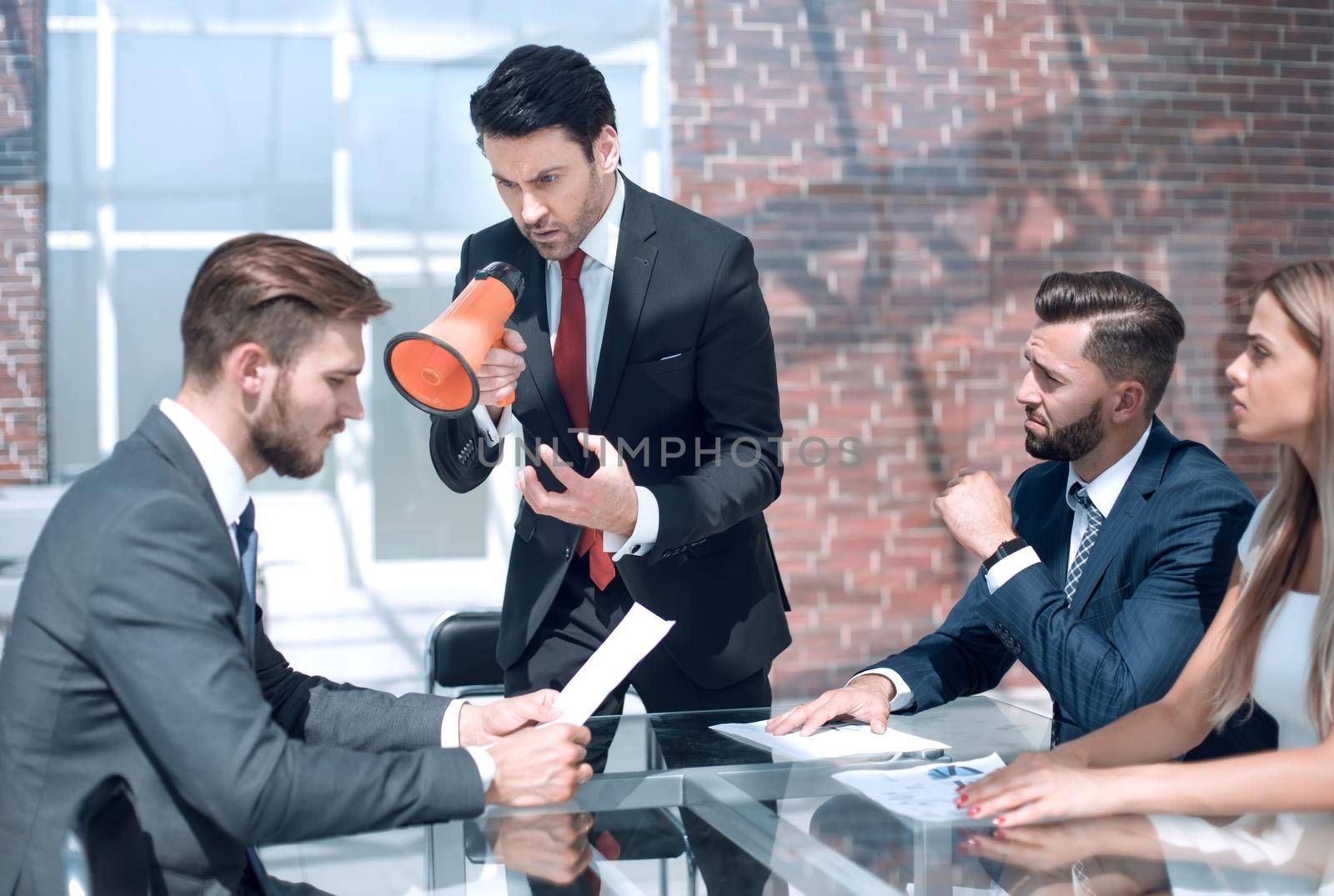 boss screams through the megaphone in the office.the concept of management