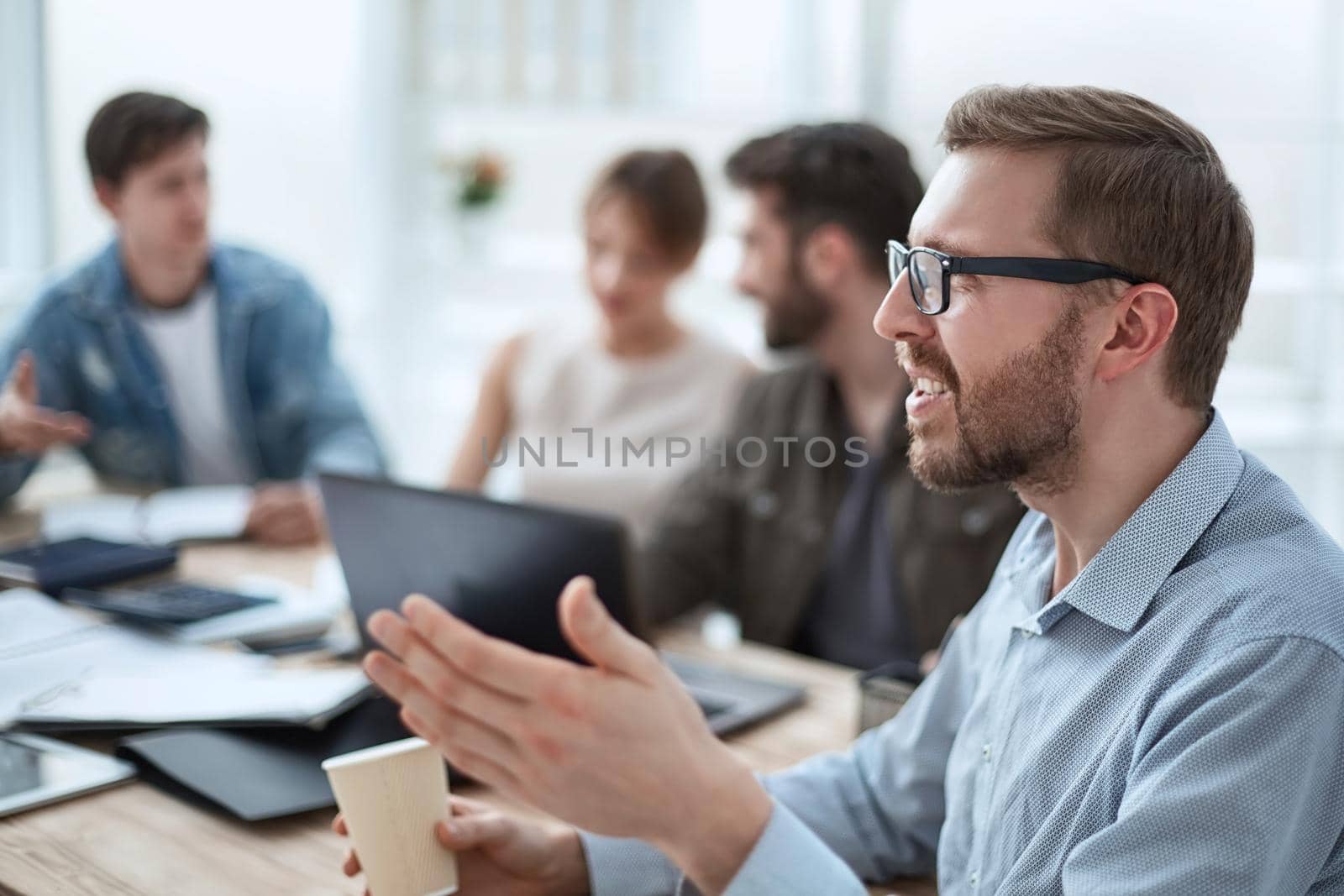 business man with a Cup of coffee sitting at a table in the office. photo with space for text