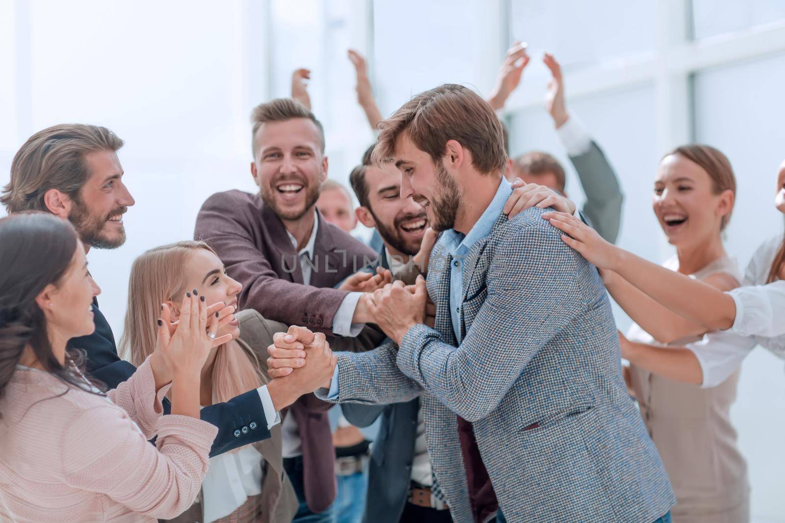 corporate group of employees applauding their colleague. photo with copy space