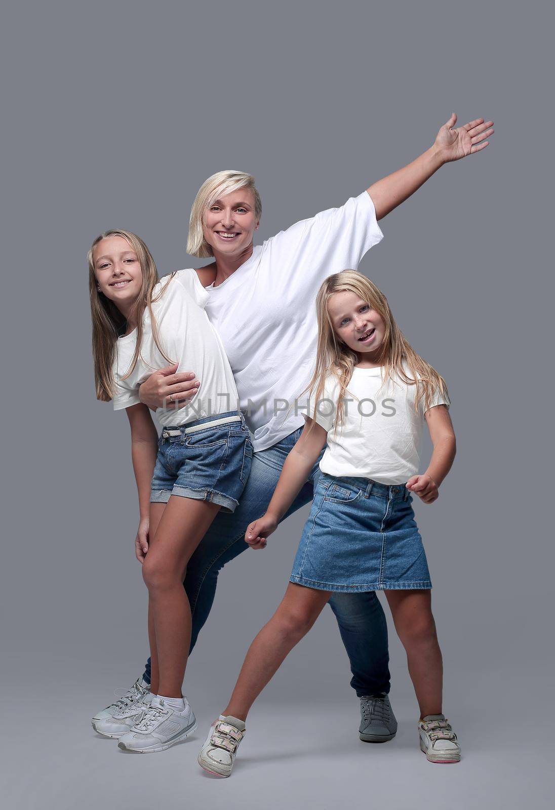 in full growth. mother and children dance together . isolated on white background