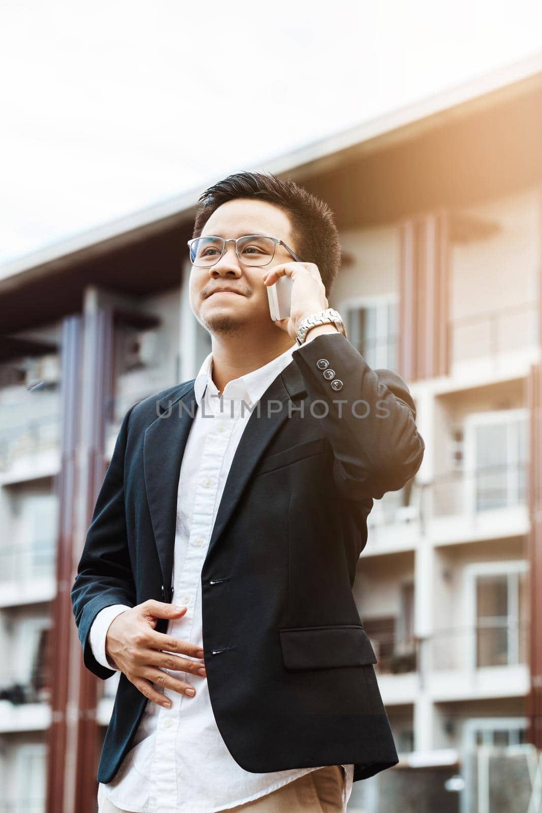 Concept Business - Business man serious talking with his project on his mobile phone. by Benzoix