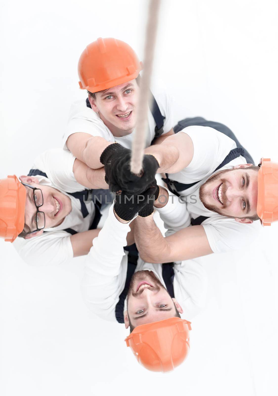 view from the top.a group of workers pulling a rope .isolated on white.