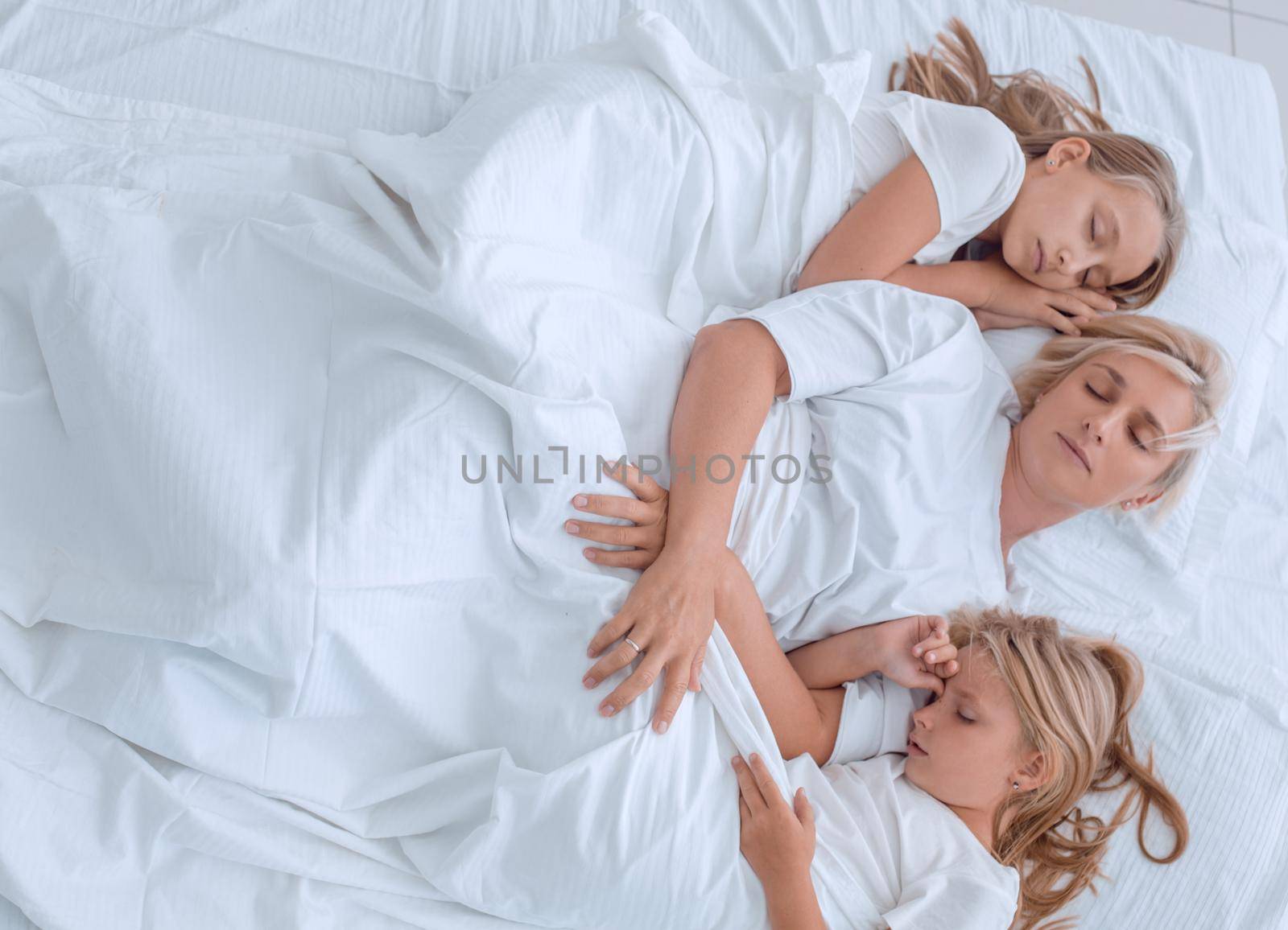 close up. two little girls are sleeping tight with their mom by asdf
