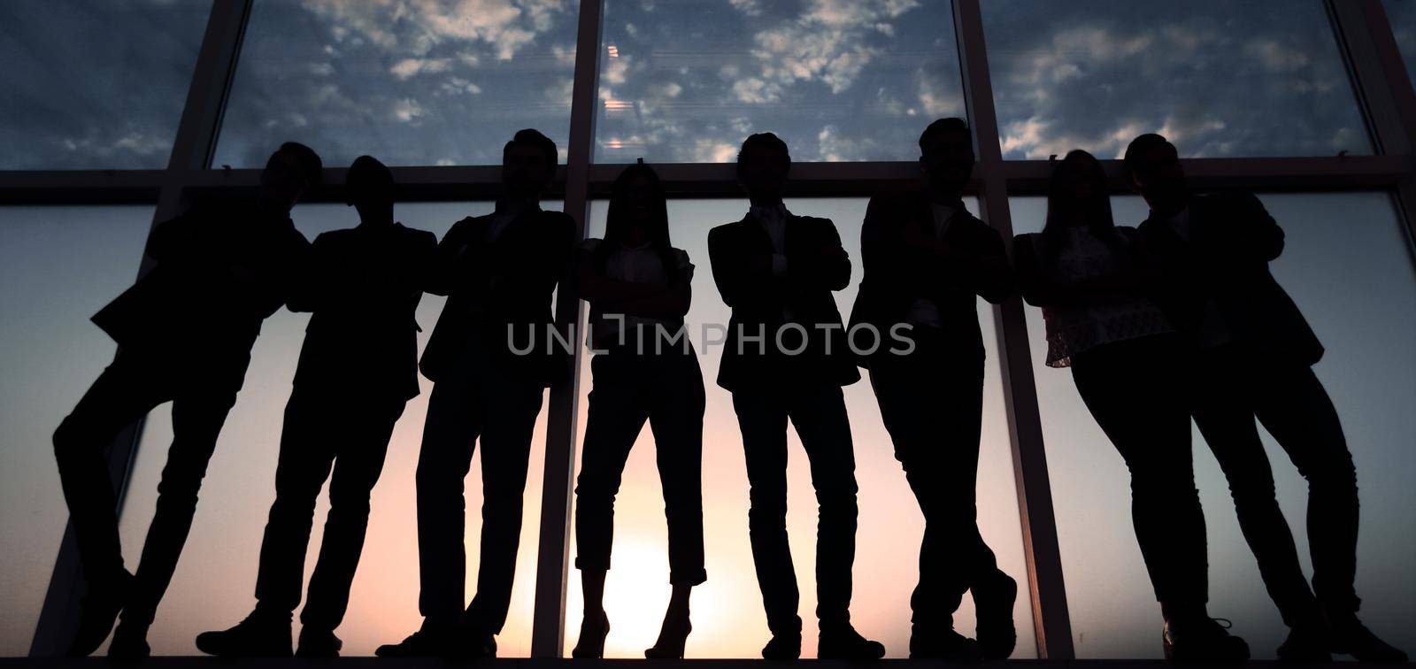 in full growth. business team standing near the office window.photo with copy space