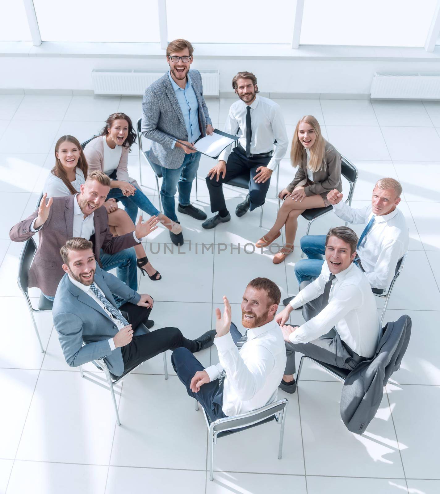 top view. business training participants sitting in a circle and looking at the camera