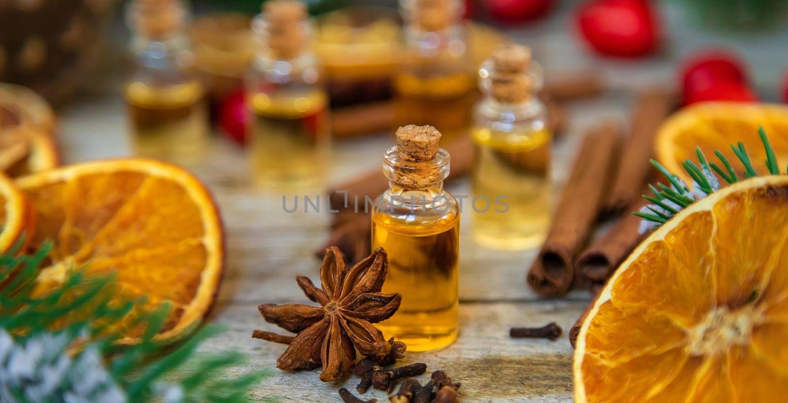 Christmas essential oils in small bottles. Selective focus. Nature.
