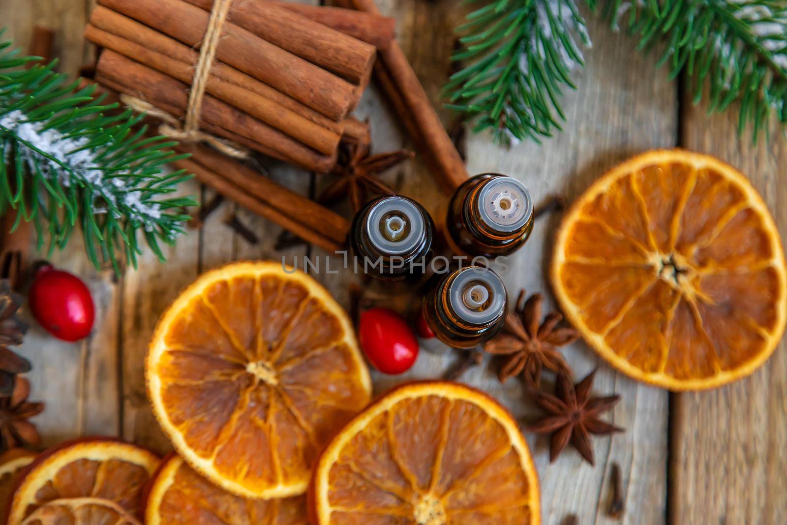 Christmas essential oils in small bottles. Selective focus. Nature.