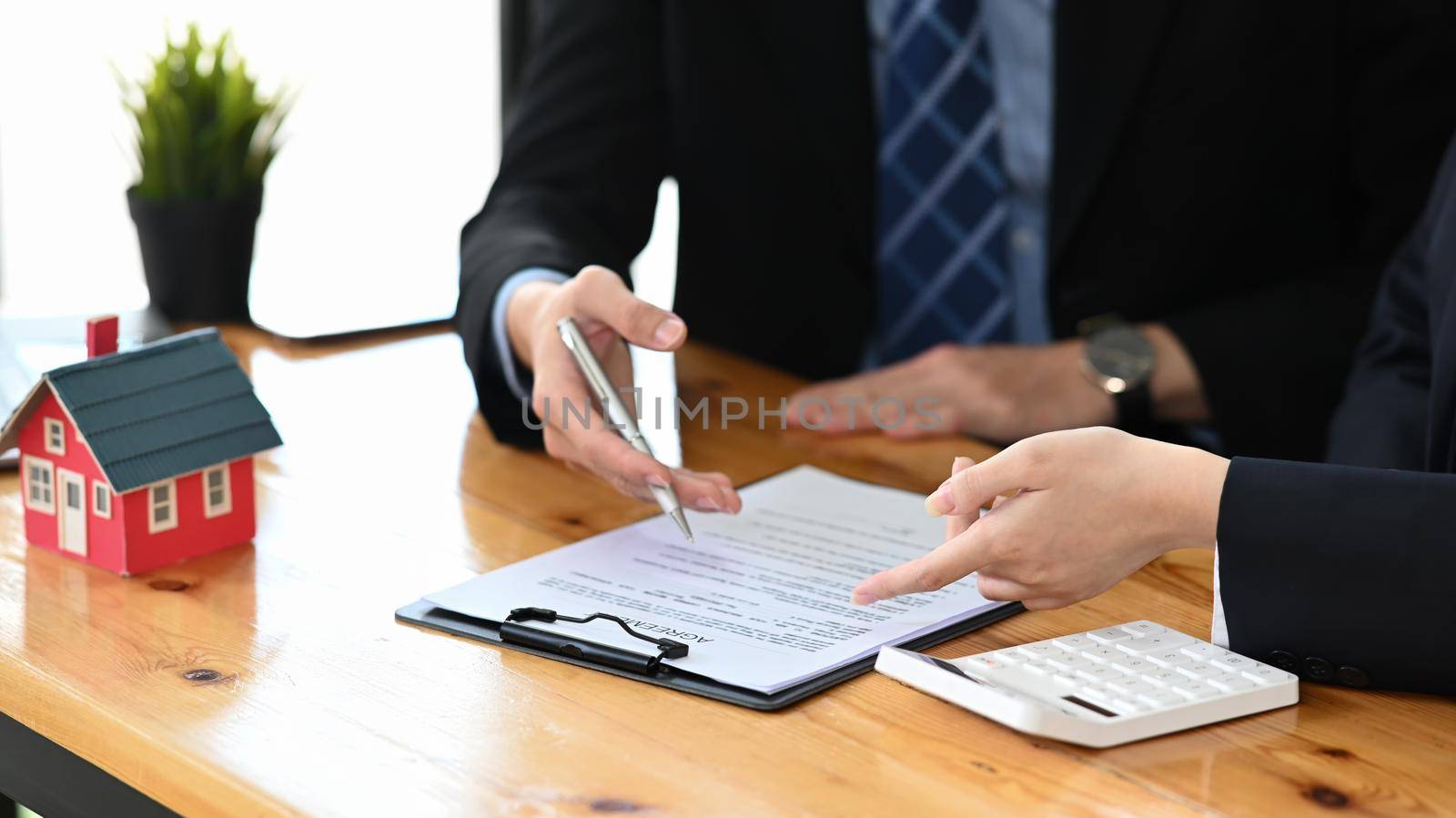 Cropped shot of real estate agent giving advice to his costumer. New house, insurance and real estate concept.