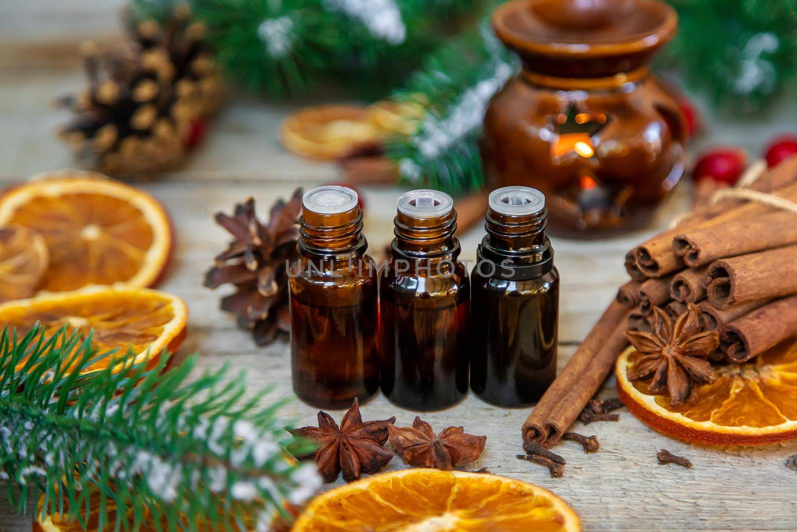 Christmas essential oils in small bottles. Selective focus. Nature.