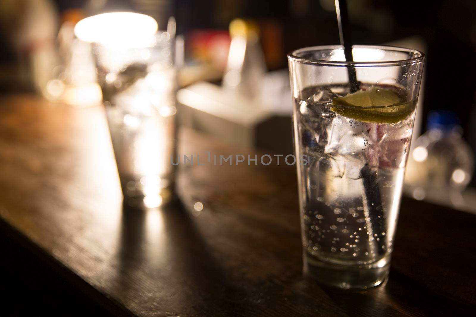 Vodka lemon with ice cubes on the bar