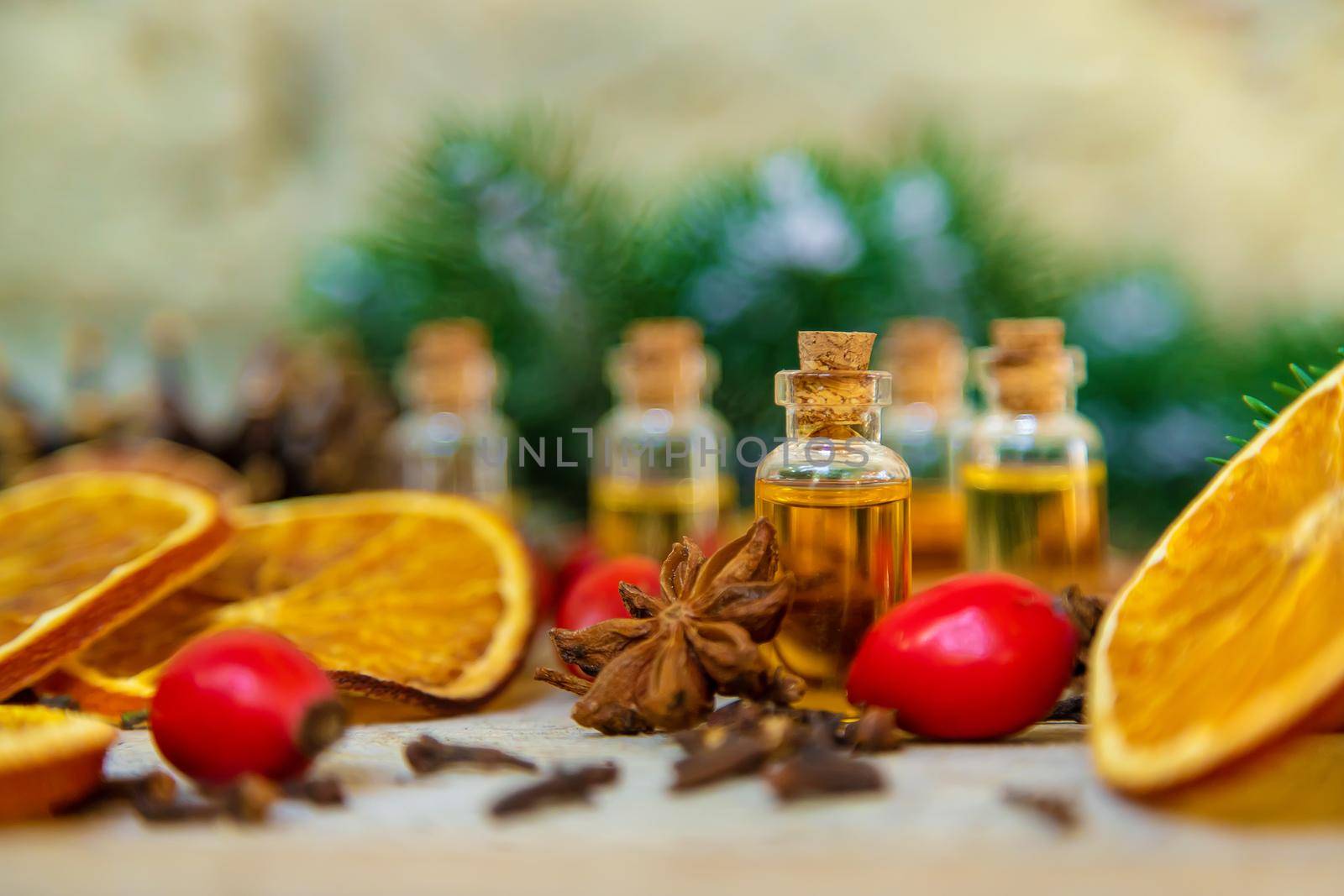 Christmas essential oils in small bottles. Selective focus. Nature.