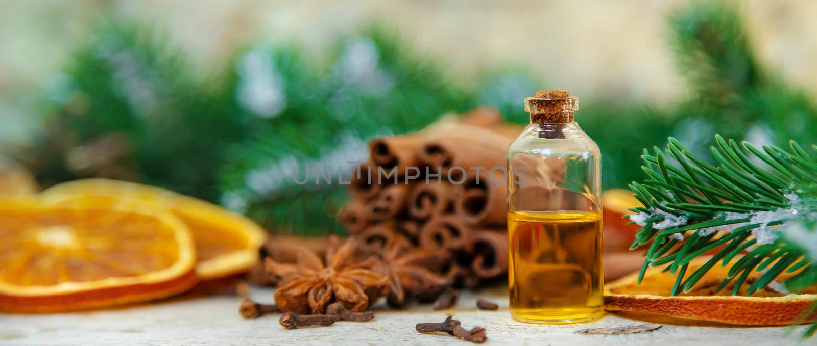 Christmas essential oils in small bottles. Selective focus. Nature.